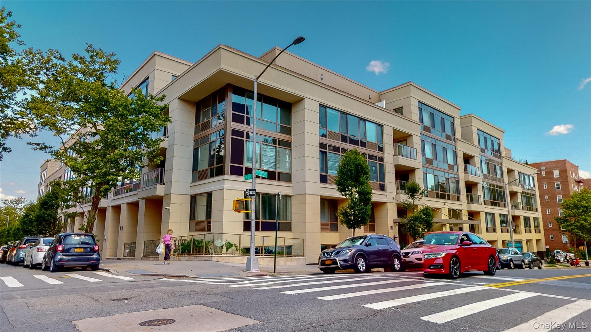Welcome to NOVO 64, a premier condominium in the heart of Forest Hills where modern design meets everyday convenience. This spacious two-bedroom, two-bath home features high ceilings, abundant natural light, and a private balcony that extends your living space outdoors. Inside, the open eat-in kitchen is equipped with stainless steel appliances, seamlessly connecting to a bright living room framed by oversized windows, hardwood floors and ample closet space that add both style and functionality throughout the bedrooms and common areas. Private Parking space in heated garage also available for purchase.As a resident of NOVO 64, youâ€™ll enjoy full-service amenities including a 24-hour doorman, resident lounge, private cinema, fitness center with sauna, massage room, and a childrenâ€™s play area. Added perks such as a complimentary morning shuttle to the subway make city living seamless. With easy access to major highways and public transportation, NOVO 64 offers a lifestyle of comfort, luxury, and connectivity.