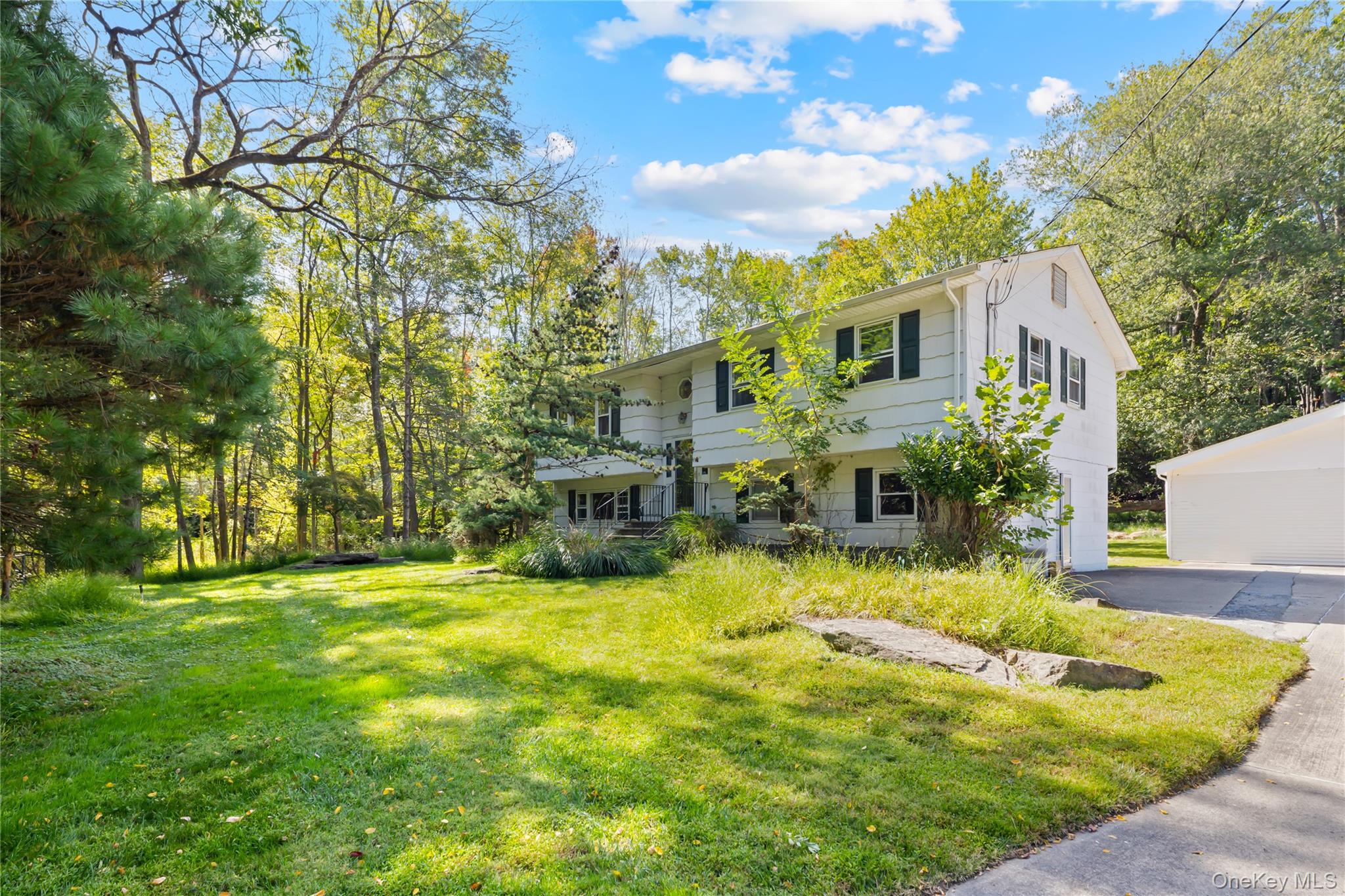Welcome to this beautifully maintained High Ranch nestled on over an acre of private property. Step inside to discover a beautifully updated kitchen and a spacious dining room, perfect for family meals and entertaining guests. This home features a fully finished lower level, offering flexible space for a family room, guest suite, home office, or recreation area. Enjoy seamless indoor-outdoor living with a large deck overlooking the peaceful, private backyardâ€”ideal for relaxing or hosting gatherings in a serene setting.