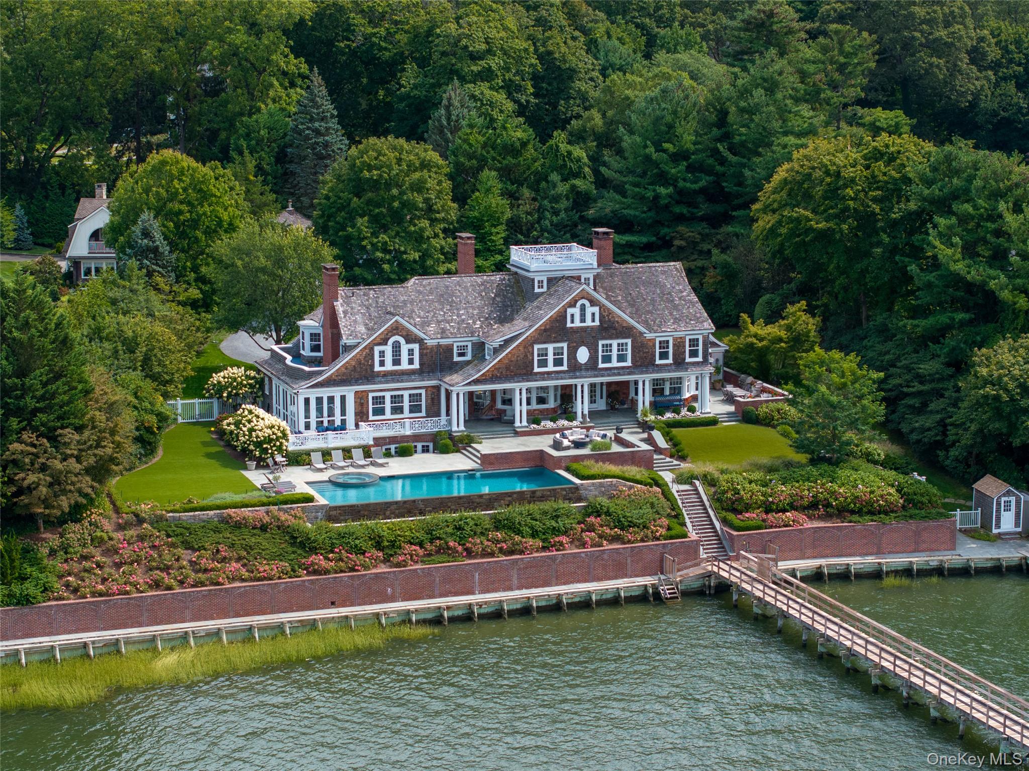 Direct Waterfront Estate with 300+ Ft Deep-Water Dock.Built in 2006 and crafted by renowned architect Oliver Cope with landscape design by Edmund Hollander and Kean Development, this 10, 000+- sq. ft. waterfront estate offers 6 bedrooms, 5 full and 2 half bathrooms, and sits on 2.35 acres of prime bay front with sweeping western exposure and panoramic views over Oyster Bay and Centre Island.At the waterâ€™s edge, a private 300+ ft deep-water dock (rebuilt in 2010) provides rare direct access for boating and yachting, anchoring the property as one of the most desirable on the North Shore. Expansive bluestone patios, manicured grounds, a covered patio, and a resort-style infinity-edge pool with spa capture breathtaking sunsets that paint the bay in spectacular color each evening.Inside, every detail has been elevated â€” from extensive custom millwork to soaring ceiling heights. A chefâ€™s kitchen with a massive marble center island flows into both grand entertaining spaces and intimate sitting rooms. A stunning library with cathedral ceilings opens to a large balcony and a private home office. Throughout the home youâ€™ll find six fireplaces, smart home technology with surveillance, a full-house generator, and bedrooms with private balconies overlooking the water.The primary suite is a true retreat, offering a spa bath, radiant heated floors, and an indoor-outdoor lounge for savoring the waterfront setting. Above, a third-floor widowâ€™s walk rooftop terrace crowns the residence, delivering the ultimate vantage point with panoramic water views and endless sunsets.The full finished lower level offers a resort-quality experience with a fitness center, sauna, steam room, cabana bath/changing room, kitchenette, and media room.A detached four-car garage completes this world-class estate â€” a rare offering that combines architectural pedigree, modern luxury, and unmatched direct waterfront living in one of Long Islandâ€™s most coveted bay front settings.