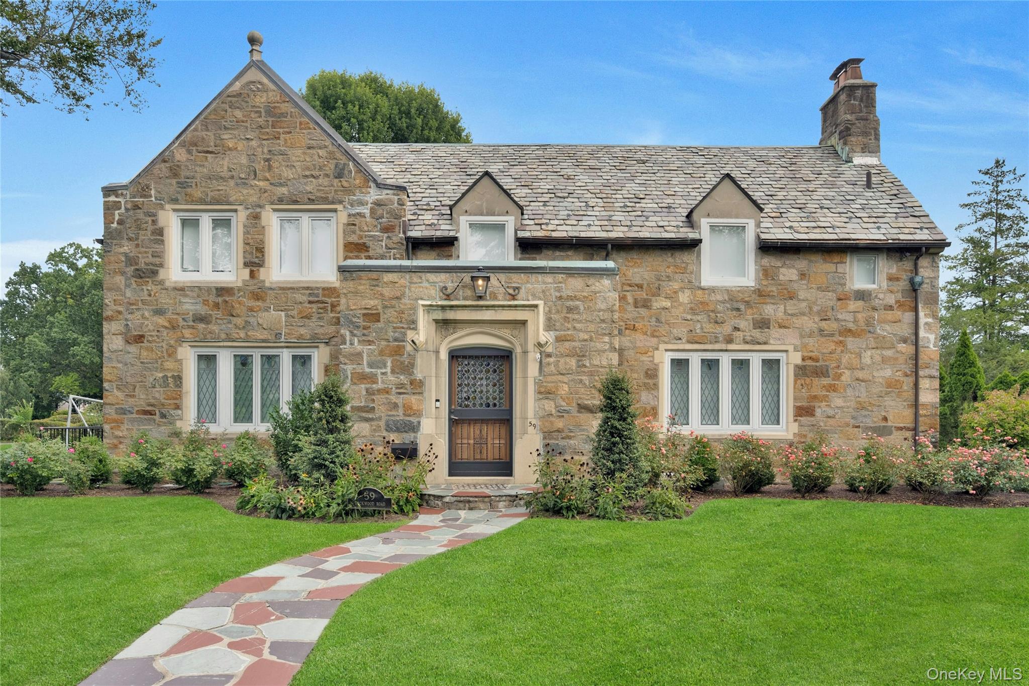 Stunningly renovated Stone Colonial in prestigious Fox Meadow neighborhood offers a rare blend of timeless character and modern sophistication. This 5-bedroom, 4.5-bath luxury home has been meticulously transformed to meet the highest standards of luxury living. Entering to this graceful foyer that leads to a sunlit living room, complete with a charming stone fireplace. The heart of the home is a custom European kitchen, a culinary masterpiece featuring a large center island, professional-grade appliances, a custom built-in beverage refrigerator, and a prep sink. The adjacent casual dining area perfect for entertaining and door opens directly to a private patio, making it an ideal setting for seamless indoor-outdoor entertaining. A convenient mudroom and access to the attached 2 car garage are also located on this level. An additional bedroom and a full bathroom complete the main floor. The second level is a private retreat. The primary suite is a true sanctuary with vaulted ceilings, custom his-and-her closets, and custom his-and-hers bathrooms offering spa-like European-style bathroom featuring a luxurious shower and a deep soaking tub. Three additional bedrooms each boast their own private en-suite bathrooms, while a sophisticated glass-enclosed home office/den provide flexible spaces for work or relaxation. The finished lower level is designed for ultimate leisure, offering a media/recreation room with surround sound. The home&rsquo;s classic appeal is highlighted by its stone exterior, professionally landscaped garden, restored windows, and a classic slate roof. Located just minutes from the vibrant & charming Scarsdale Village and the train station, easy commute to NYC, shopping, parks, walking paths, etc. This home offers the perfect balance of serene residential living and urban accessibility. Experience the pinnacle of luxury and convenience! Great Opportunity to live in exclusive Fox Meadow area.