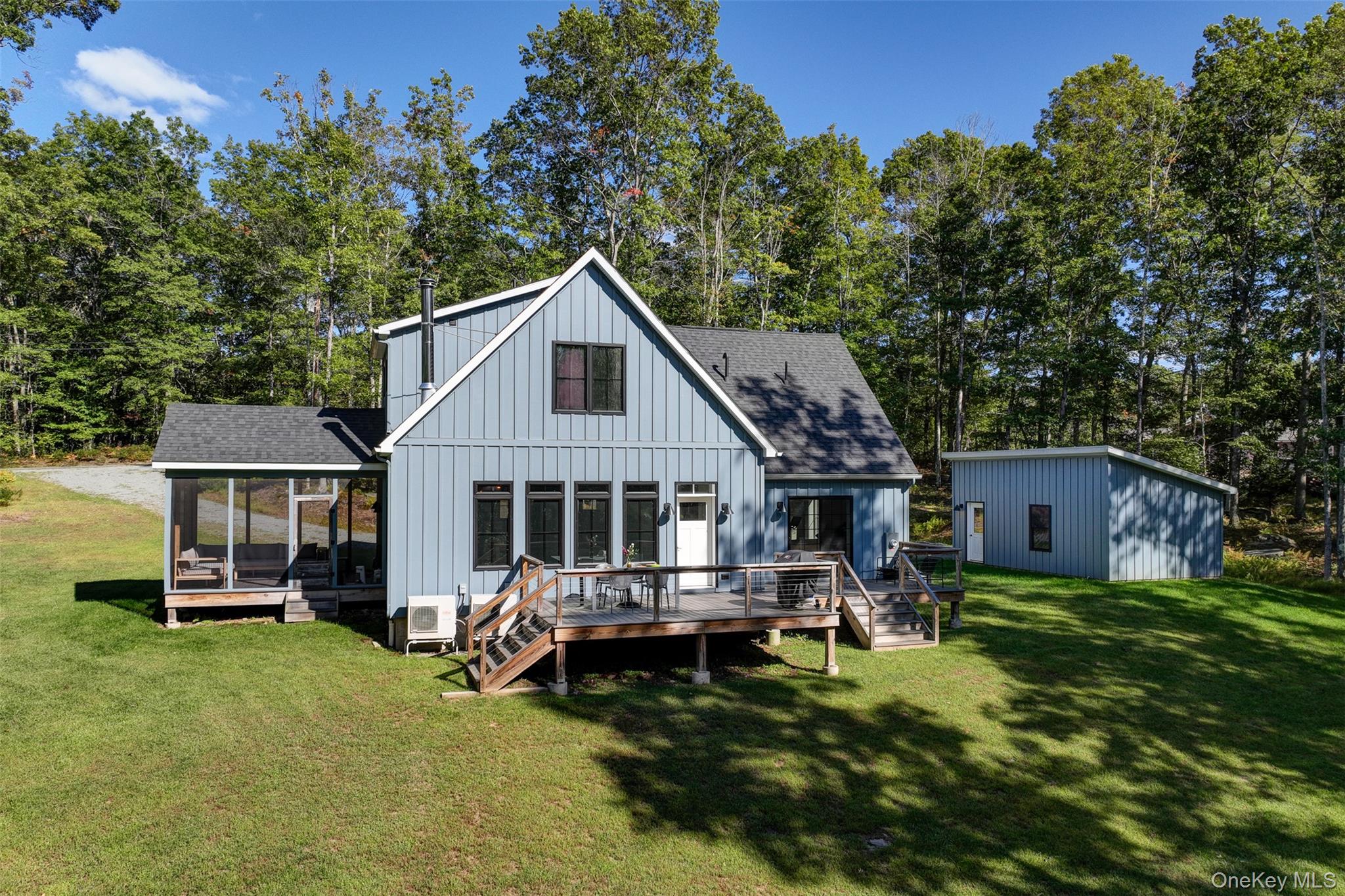This 3-bedroom, 2.5-bath residence sits on 10 private acres, ideally situated between the sweet river hamlets of Callicoon and Narrowsburg, NY. Designed with both sustainability and comfort in mind, the home combines energy efficiency with modern country living. â€¢ The exterior is clad in low-maintenance LP SmartSide engineered wood, while oversized casement windows flood the interiors with natural light. Heating and cooling are handled entirely by efficient mini-splitsâ€”no fossil fuels required. â€¢ The heart of the home is the great room, where kitchen, dining, and living spaces flow together under high ceilings. The kitchen offers Corian countertops, a generous island with seating for four, and a vented oven. A modern chandelier sets the mood above the dining table, while in the living area, a Malm hanging fireplace and a wall of windows invite cozy evenings and conversation. A very handy half bath is adjacent to the entrance. â€¢ From here, two outdoor living spaces extend the homeâ€™s footprint: a screened porch with room to lounge, and a broad deck accessible from both the living area and the primary suite. The deck is sized for summer gatherings and dining under the stars, with the added perk of an outdoor shower. â€¢ The first-floor primary bedroom is a spacious retreat, with ample closet space, deck access, and a spa-like bath featuring a double vanity and glass-enclosed shower. An attic offers extra storage or the potential for vaulted ceilings. Upstairs, two large bedrooms share a full bath with tub and the convenience of a washer/dryer. The home was crafted by Catskill Energy Homes, a builder known for marrying sustainability with thoughtful design. Here, modern efficiency and Catskills tranquility come together across ten wooded acres.