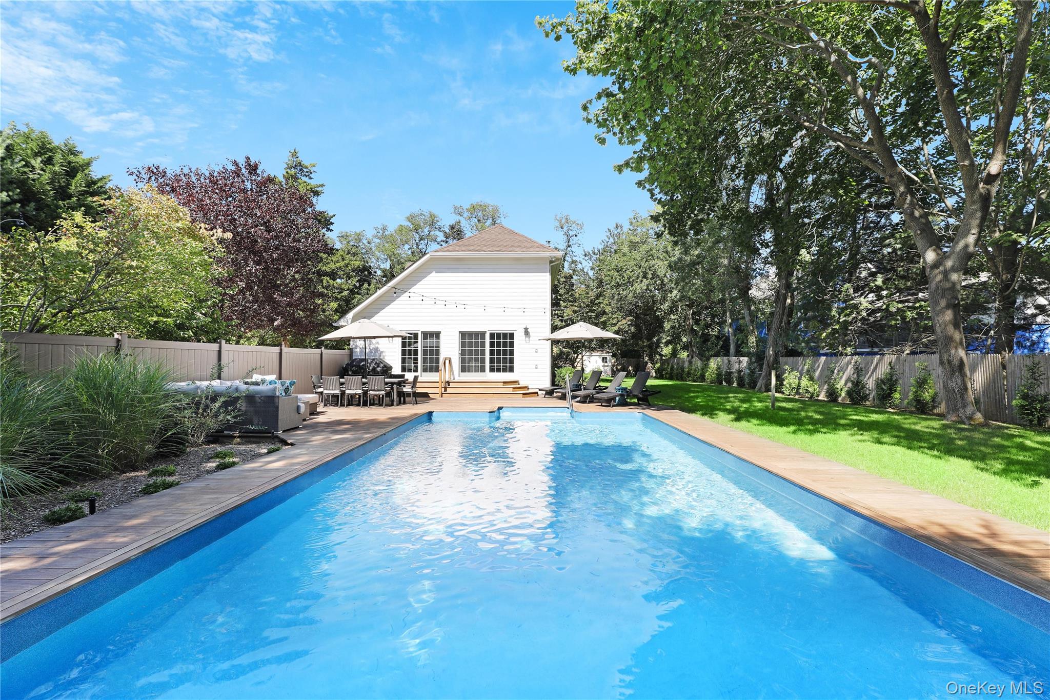 Located south of the highway, this fully renovated immaculate Westhampton gem is ready for summer of 2026. Featuring a bright open concept, the first floor consists of a kitchen, dining area with cathedral ceilings, living room, half bath, laundry room and two bonus rooms. The second level offers an en-suite, and master bedroom with a large bathroom & jacuzzi. The manicured backyard is ready to entertain your guests with a heated in-ground salt water pool, ipe decking, dining area and ample space for family activities. Dune Road beaches and Westhampton Beach Village are just minutes away! **AVAILABLE FOR: May ($20K)  June ($30K)  July ($40K)  August-LD ($40K)  September ($15K)  Memorial Day - Labor Day ($110K) **