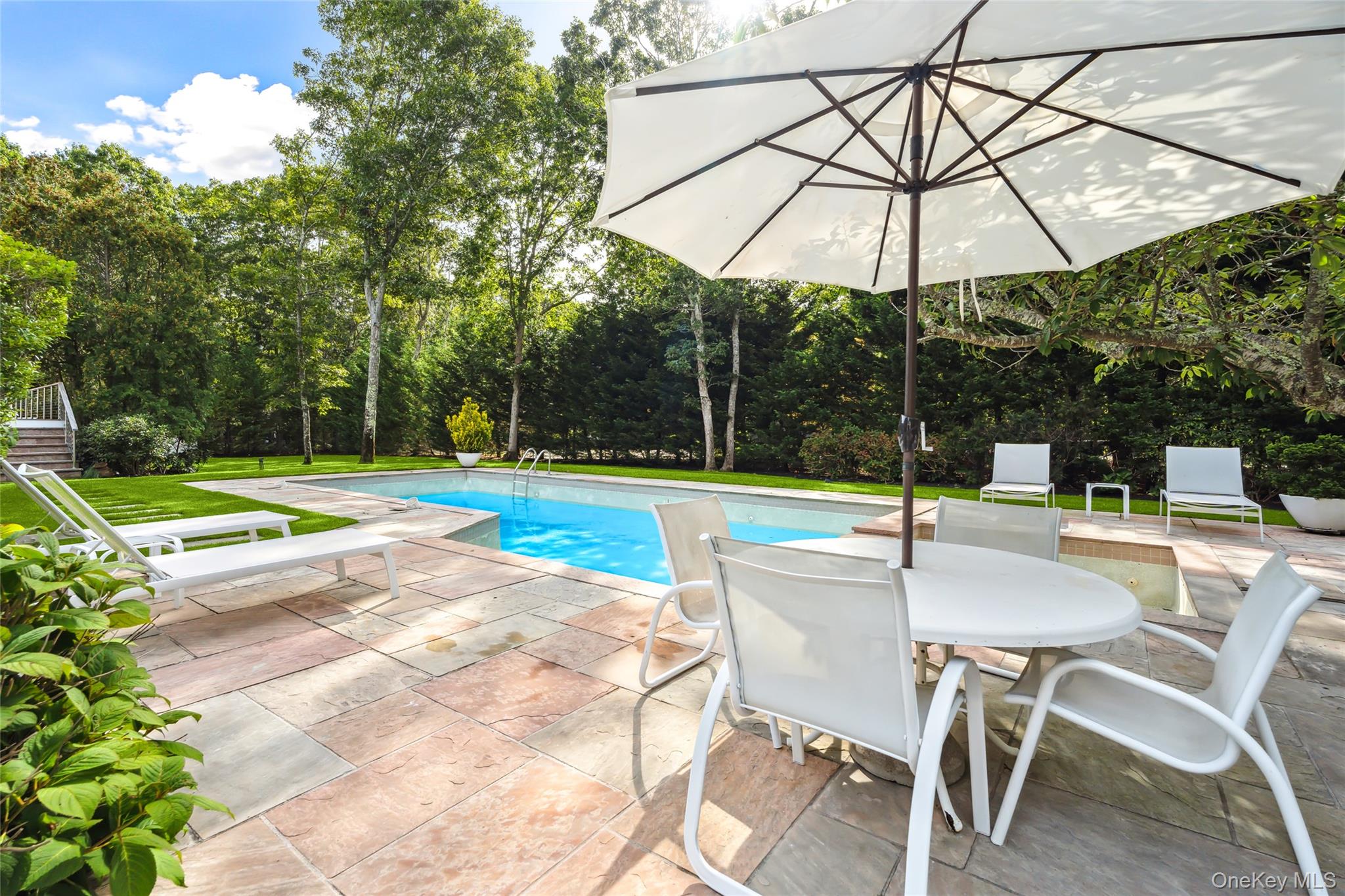 QUOGUE VILLAGE CONTEMPORARY Enjoy your vacation in this turn-key 4 BR/4 BA rental compound located on a quiet street in Quogue village. The chic multi-level home features 3 guest bedrooms, a lower-level den, and a private primary suite on the top level. The main floor has soaring ceilings, an open kitchen, a bright living room with fireplace and comfortable seating, and an adjacent music/sitting room. A wall of glass sliders lead from the central living and dining area to an ample deck overlooking a heated gunite swimming pool with spa and a har-tru tennis court. The entire compound is surrounded by mature plantings and meticulous landscaping. This ideal Hamptons getaway is less than three miles from the desirable Quogue Village beach, close to shops and transportation, and only 90 minutes from New York City. Available October ($15k); Nov-March ($6k/mo, 3mo min); April ($10k); May ($20k): June ($30k); July ($40k).