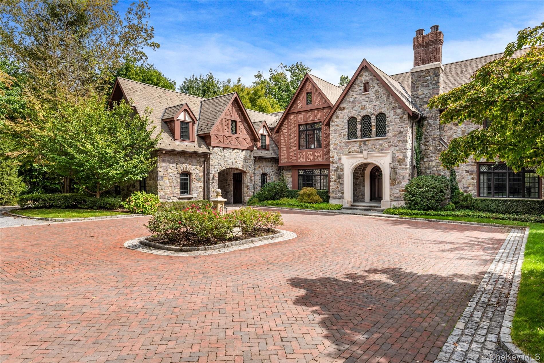 Hidden Gem â€“ A Timeless Tudor Masterpiece on 2.7 Acres. Tucked away down a serene private road in the prestigious Village of Great Neck, this hidden gem is a 11, 000-square-foot Tudor mansion, custom built in 2009 with the highest level of craftsmanship and attention to detail. A striking exterior of hand-cut stone and arched leaded-glass windows evokes the grandeur of old-world architecture, while the interior is thoughtfully designed for todayâ€™s modern lifestyle. The grand entry foyer sets the tone for this stately residence, flowing seamlessly into expansive entertaining spaces. A formal living room and elegant dining room with butlerâ€™s pantry provide the perfect setting for sophisticated gatherings, while the state-of-the-art chefâ€™s kitchen with double appliances, custom cabinetry, and a sunlit breakfast room caters to both grand entertaining and everyday living. This residence is designed with both comfort and elegance in mind, offering 7 ensuite bedrooms and 2 additional guest suites. The lavish master wing is a true retreat, complete with a private sitting room and fireplace, two walk-in closets, and a spa-like marble bathroom featuring a soaking tub and oversized shower. The walk-out lower level is an entertainerâ€™s dream, boasting soaring ceilings, a custom catering kitchen that doubles as a pool cabana, and vast flexible space for recreation, fitness, or entertaining on a grand scale. Outdoors, the estate is equally impressive. Set on over 2.7 acres of professionally manicured grounds, the property offers a resort-like lifestyle with a sparkling in-ground swimming pool, separate jacuzzi, expansive covered patio with a large stone fireplace, and multiple areas for lounging and dining al fresco. A three-car garage and sweeping driveway complete this extraordinary offering. This hidden gem combines timeless Tudor architecture with modern luxury amenities, offering a true Gold Coast masterpiece for those who value elegance, privacy, and unparalleled comfort.
