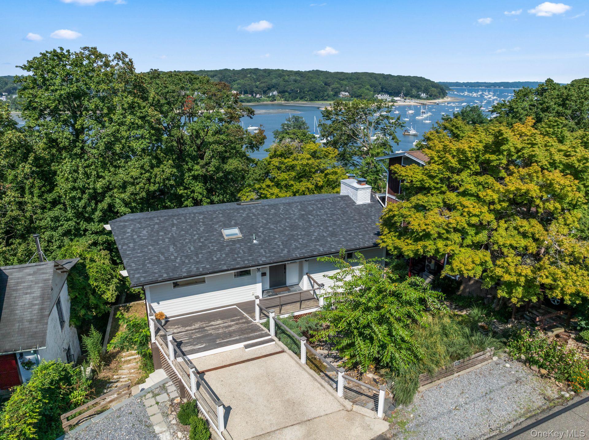 Quietly nestled just moments from Northport Harbor and the vibrant Village, this fully reimagined 3-bedroom, 2.5-bath home offers three levels of curated living and refined coastal design. Gut-renovated in 2022, the residence blends timeless craftsmanship with modern elegance featuring soaring ceilings, restored white oak floors, a custom handcrafted staircase, and a designer kitchen with Danby marble, quartz surfaces, and soft-close cabinetry. Seasonal water views create a serene, ever-changing backdrop particularly striking in winter when the harbor reveals itself through the trees. With deeded mooring rights, access to private beaches, and proximity to downtown shops, dining, and cultural attractions, this home captures the best of Northportâ€™s coveted waterfront lifestyle