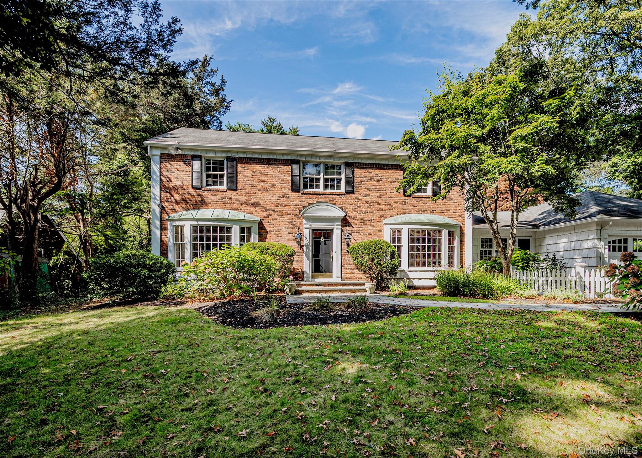 Expanded Colonial on shy half-acre at the gateway to Lloyd Harbor. Classic, traditional layout featuring 4 bedrooms, 2 full and 2 half baths. Expansive custom gourmet kitchen with high-end finishes and large center island. Two spacious family rooms, each with a fireplace. Formal dining and living rooms offer ideal entertaining space. Private home office perfect for remote work. Separate mudroom entrance adds everyday convenience. Bluestone patio overlooks beautifully landscaped yardâ€”ideal for outdoor gatherings. Prime location close to beaches, village, and transportation.