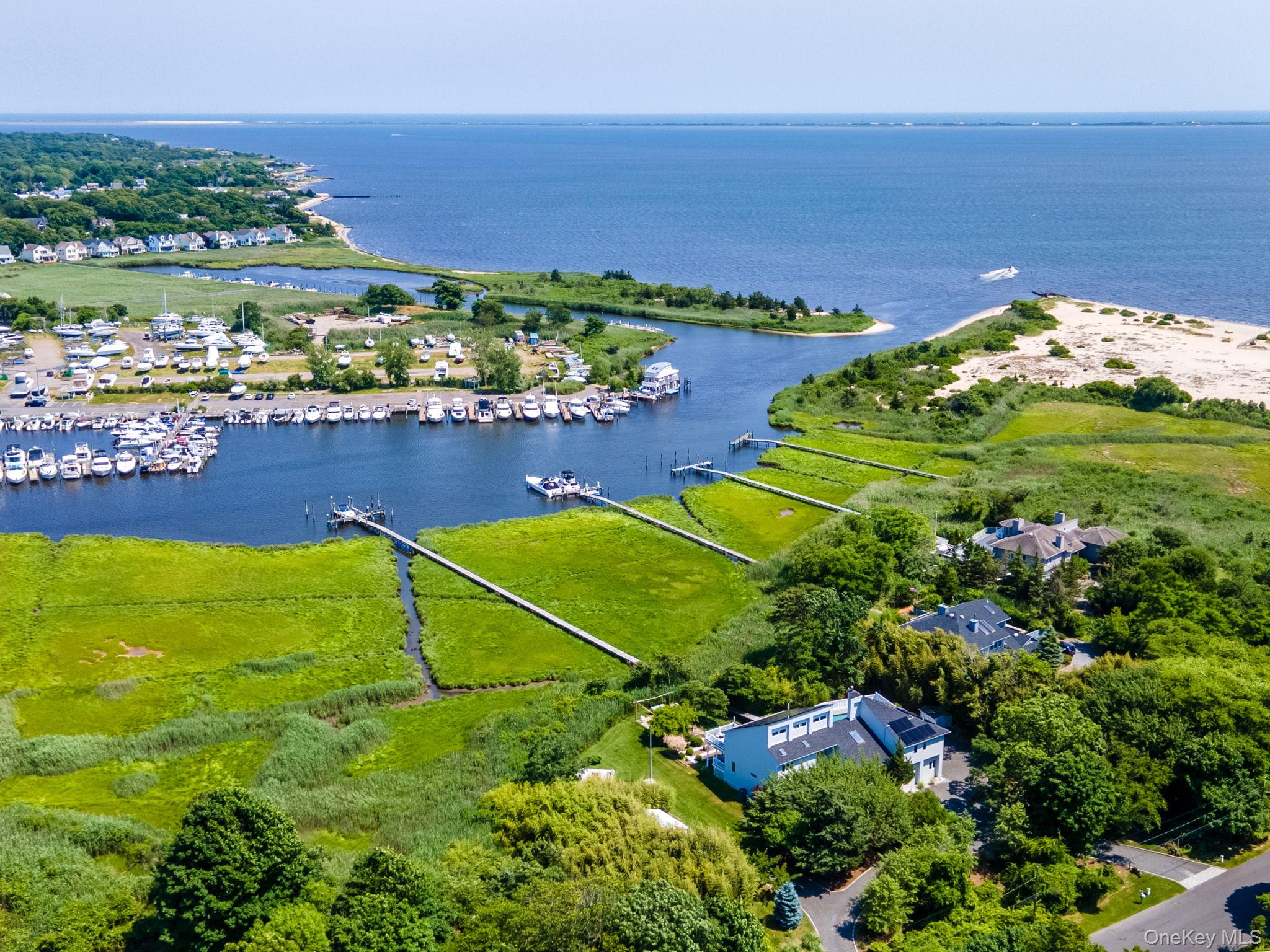 Welcome To This Waterfront, Stunning Contemporary Home With 5 Boat Slips And Easy Access To The Great South Bay. This Luxurious Living Space Spans Over 3, 000 Square Feet And Features Breathtaking Views, Modern Updates, And Picturesque Lighting. As You Enter The Two-Story Foyer, You Are Greeted With Modern Details Throughout. The First Floor Includes A Spacious Den Leading To 3 Bedrooms And A Beautifully Remodeled Full Bath. A Sunroom Allows For Indoor Enjoyment With A Full View Of The Pool Area, Making It A Perfect Gym Or Sitting Room To Relax. Upstairs, You&rsquo;ll Find A Breathtaking Open Great Room With Picturesque Views Through The Floor-To-Ceiling Sliders Of The Water/Canal. Absolutely Breathtaking! The Magnificent Gourmet Kitchen Features Skylights, Stainless Steel Appliances, And A Large Breakfast Bar-Perfect For Entertaining. The Elegant Main Bedroom Includes A Loft Office With Water Views, A Private Balcony Overlooking The Grounds, A Spa-Like New Bathroom With Steam Shower and Smart Toilet, And A Walk-In Closet, Adding A Level Of Sophistication. The Amazing Outdoor Living Space Includes A 20X40 Gunite In-Ground Pool, An Outdoor Full Bathroom, Wraparound Decks With A Hot Tub, And Expansive Multi-Level Decks All With Views Of The Water And Private Sanctuary. Along The Yard, There Is A Cozy Fire Pit Area, A Beautiful Vine-Covered Pergola, And An Outdoor Kitchen Area. A Scenic 400-Foot Walkway Leads You To A Private Dock With Electricity And 5 Boat Slips. The Deep Canal Allows For Large Boats To Take A Ride Out For A Day At Fire Island Or A Tour Of The Great South Bay To View The Most Beautiful Sunsets. For Added Convenience And Incredible Savings, There Are Newer Solar Panels That Can Be Easily Transferred To Purchaser. This Home Is Perfect As A Vacation Home Or For Year-Round Living. Perfectly Located Between Patchogue And Bellport Villages.