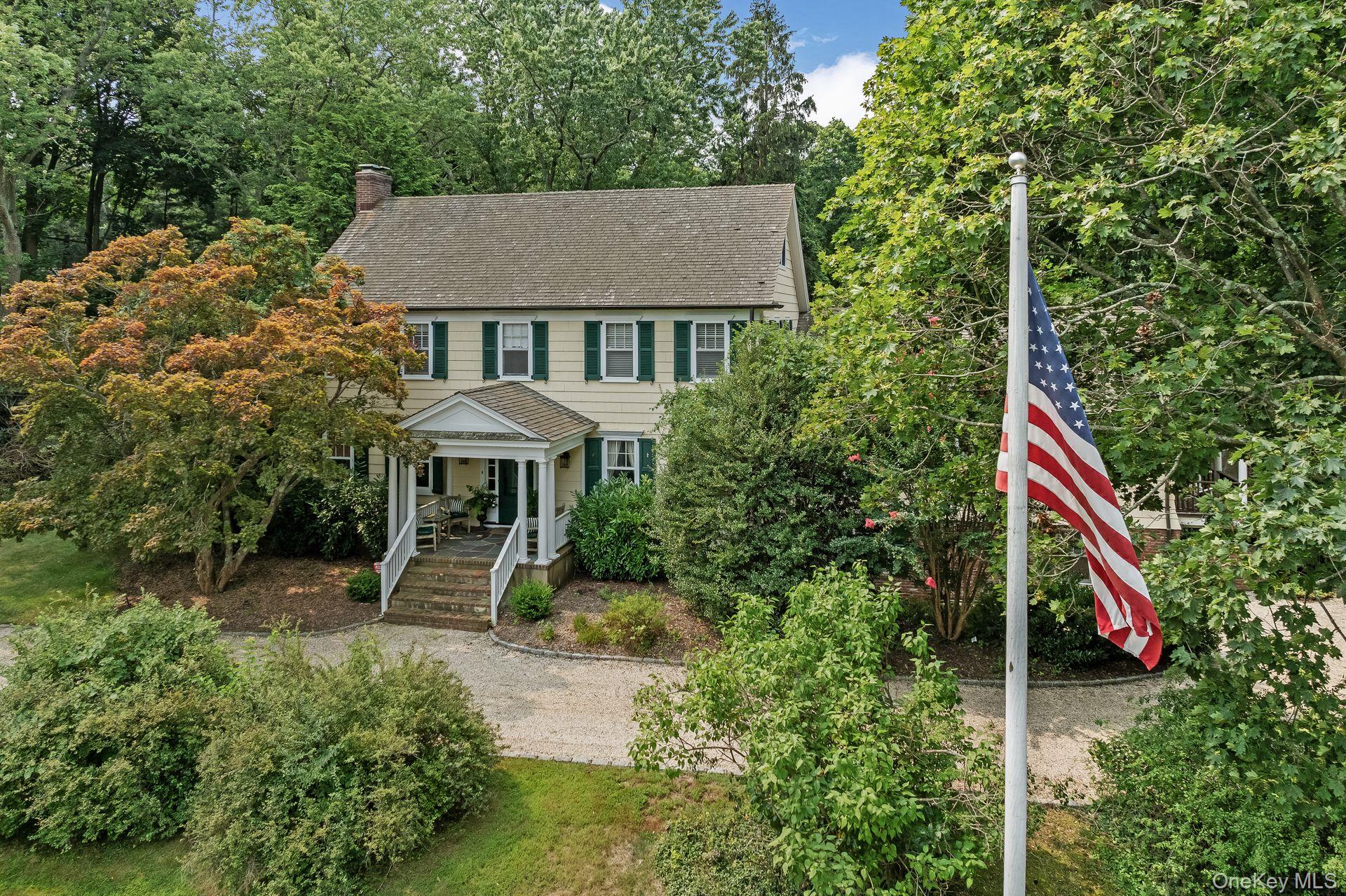 Set on just over two serene acres in the Village of Lloyd Harbor, 1 Beardsley Lane is a classic Colonial that combines timeless character with modern amenities. Built in 1927, this residence offers a thoughtfully designed living space, featuring six bedrooms and four full bathrooms across three levels. A welcoming foyer opens to a formal dining room and a spacious living room with a wood-burning fireplace. At the heart of the home is a well-appointed chefâ€™s kitchen with an oversized island, marble and stone countertops, stainless steel appliances, and a sunlit breakfast nook with views of the backyard. The kitchen flows seamlessly into a cozy den with built-in wet bar. A full bathroom, laundry room, and mudroom complete the main level. Upstairs, the expansive second level features a serene primary suite with a second fireplace, dual closets with seating area, and an en suite bath. Three additional bedrooms and a full bathroom offer flexibility to accommodate a variety of lifestyle needs. The third floor includes two more bedrooms and an additional full bathroom, ideal for guests, work-from-home setups, or creative spaces. The lower level includes a dedicated exercise room, wine cellar, media room, and additional storage space, providing both comfort and functionality. Interior highlights include radiant heated floors, custom millwork, recessed lighting, a built-in speaker system, high-speed connectivity, and more. Outside, the beautifully landscaped grounds feature mature plantings, an expansive patio, and a fenced in-ground Gunite pool with diving board. Located within the Cold Spring Harbor School District and Incorporated Lloyd harbor village with access to local amenities including camp, tennis, moorings and beach.