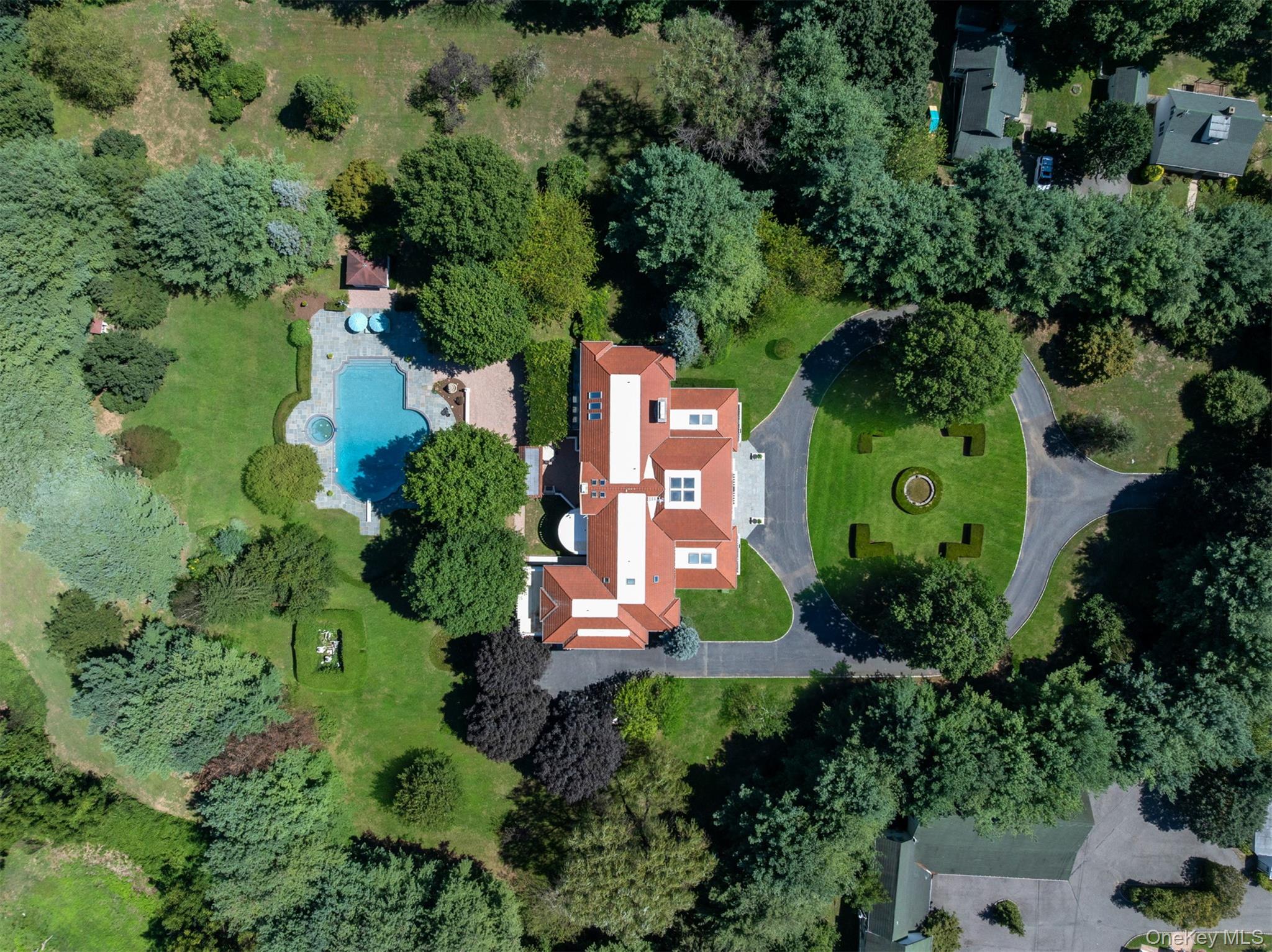 Welcome to 23 Old Westbury Road, an extraordinary private compound set on approximately 16 acres of fully landscaped grounds in one of Long Islandâ€™s most prestigious enclaves. At its heart stands a -10, 000 sq. ft. Mediterranean-style brick mansion of commanding presence, complemented by seven additional legal residences, 14 garages, two large barns, and a U-shaped horse stable. The estate offers resort-level amenities, including an Olympic-sized heated in-ground pool of nearly 90, 000 gallons with jacuzzi, a full outdoor kitchen, and manicured gardens designed for grand entertaining and tranquil living alike. Zoned for two acres with non-conforming use, the property presents a rare opportunity to subdivide or reimagine, unlocking tremendous value for a buyer seeking not only a remarkable lifestyle but also a sound investment. Whether envisioned as a multi-generational compound, equestrian estate, income-producing asset, or backdrop for film and media productions, this property offers versatility at a scale seldom seen. Perfectly situated just 30 minutes from New York City and minutes from public transportation, 23 Old Westbury Road delivers privacy, prestige, and long-term potentialâ€”an unparalleled acquisition for both use and investment.