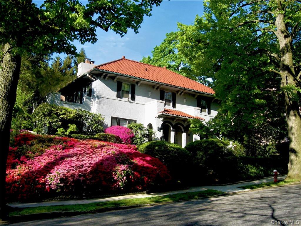 This stately Mediterranean villa near Bronxville is set high on a private, lushly landscaped large corner property. The flagstone walkway leads to a refined entry door with brass lion-head knocker and into the grand foyer featuring a sweeping curved staircase with distinctive balustrades. Center hall layout with all oversized rooms is perfect for entertaining and relaxing. Two sets of leaded-glass double French doors open to the ballroom-sized living room and elegant dining room, both with intricate moldings, gleaming maple floors and custom fireplace. All walls and ceilings are hand-crafted Venetian plaster. Sun-drenched wood paneled home office or first floor bedroom has new bay window and built-ins. A bath with gold fixtures is also on the first floor. The updated kitchen and butlerâ€™s pantry have stunning granite counters, a breakfast nook and handy mud room. Amenities include a lower level in-law apartment with full bath, separate access and expansion possibilities. Upstairs, the huge ensuite primary bedroom has its own private 220 SF terrace, cedar closets, and enormous tiled bath with separate shower room. The lower level, with rec room, laundry, full bath with shower, and playroom, accommodates au pair or in-law. The heated, two-plus car garage is below the house, with indoor direct access. Third floor has additional 1, 500 SF with cathedral ceiling (not included in house square footage) with space for 5th and 6th bedrooms and full bath. New 200-amp service and new electric throughout. Freshly painted, inside and out. Very private yard has fully operable in-ground gunite mini pool that provides a special outdoor oasis. Massive stone walls, terraces, patios, and full property sprinkler system. Ludovici lifetime barrel tile roof is spectacular. Some furnishings included. Short walk to Metro North. NYC commute is 25-minutes from Fleetwood or Bronxville. Shopping in Fleetwood and Bronxville. Low taxes are before STAR reduction. MOVE-IN READY. Photos are real, not staged. Low cost per square foot.