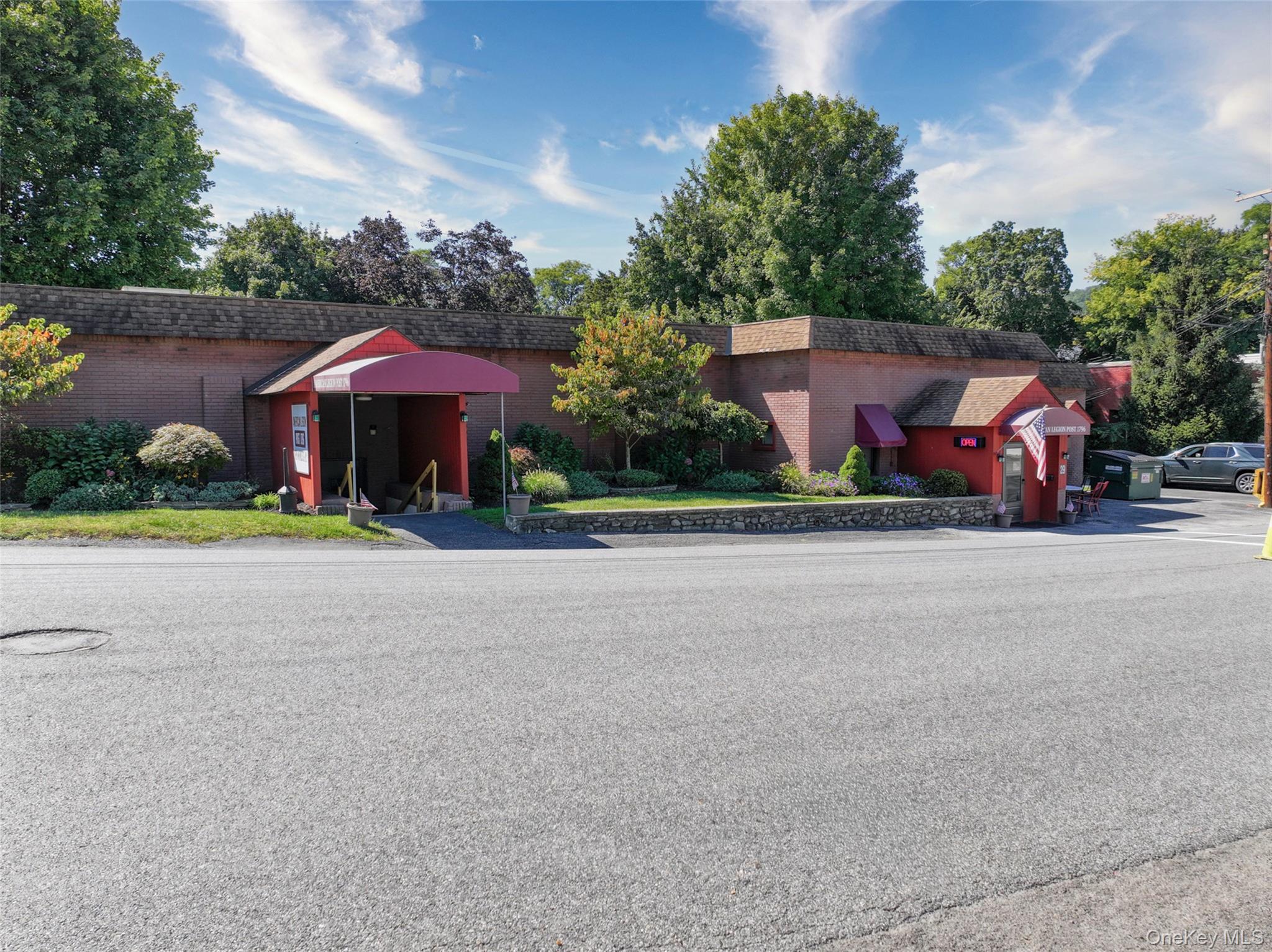 This property is zoned Planned Industrial (PI). It must be used for a similar function by an organization. Any change in usage would have to be approved by the planning board. There are multiple entrances for meetings/functions. Enter into the bar area with high top tables. The dining area opens to the commercial kitchen with an up-to-date Ansell fire protection system over the 10 burner Garland range with dual ovens. There is a meeting room/hall that seats over 100 for parties with additional space for a stage. There is cental air throughout the building with built-in wall units in the private office. Storage abounds with a walk-in cooler and tap room, a locked room to secure beverages plus commercial ice machine and additional rooms for supplies. The large flat parking lot has room for over 50 cars.