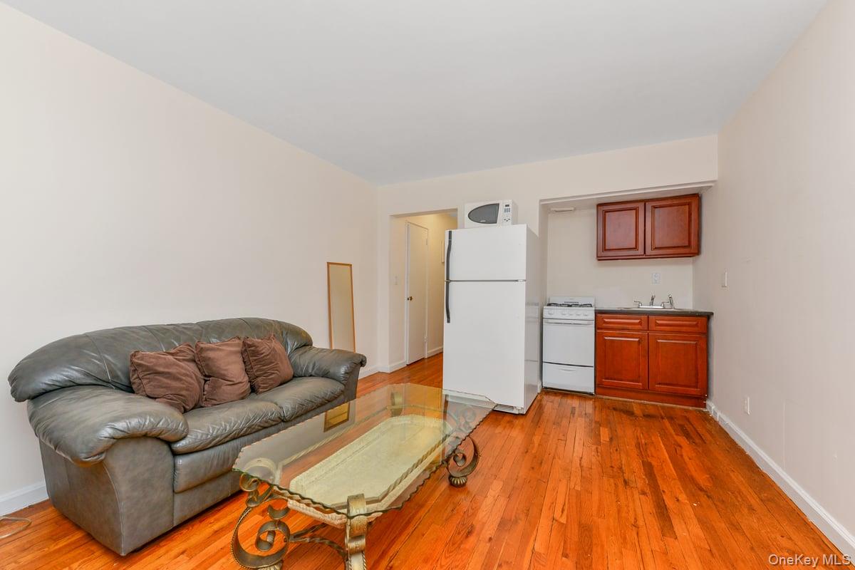 Welcome to this sun-filled studio perfectly situated in the vibrant heart of Great Neck. This well-maintained unit features beautiful hardwood floors throughout, an open-concept kitchen and living area with modern countertops, and three spacious closets offering ample storage. The bathroom has been freshly painted, and the building is professionally managed with a live-in superintendent.Enjoy on-site laundry facilities and the convenience of parking (available via waitlist). A commuterâ€™s dreamâ€”just a few blocks from the LIRR station, providing a quick 30-minute ride to Midtown Manhattan.