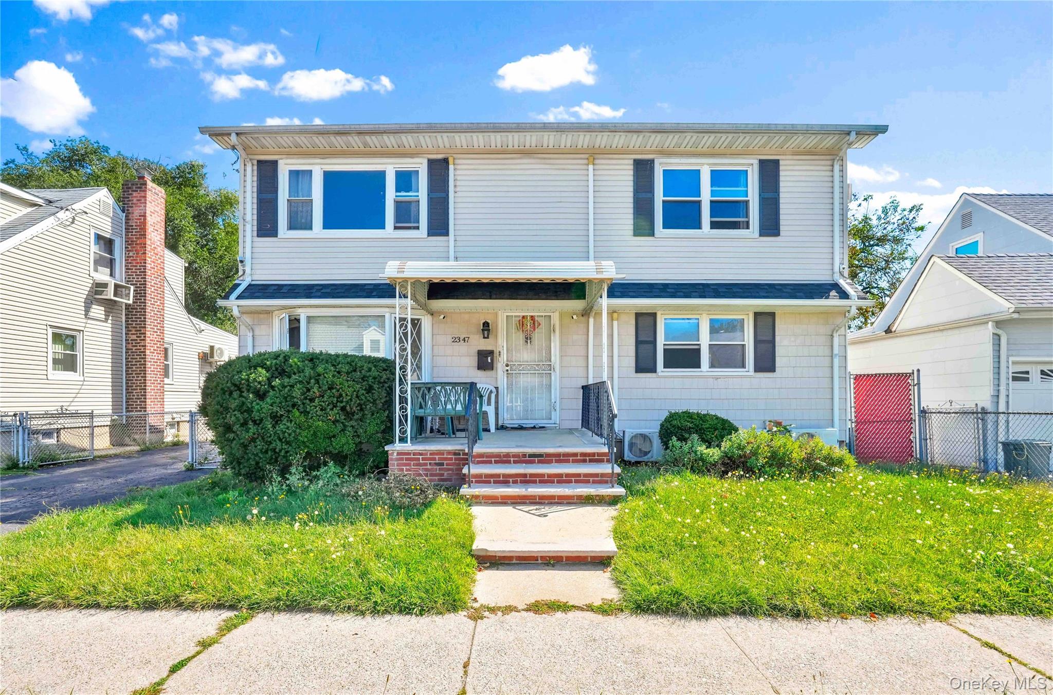 New to Market â€“ Legal Two-Family Colonial ideally located mid-block on the Flushing/College Point border. This spacious 4 BR / 2 BA home sits on an oversized 54&#215;98 lot with a 36&#215;24 house footprint and 2, 210 sq. ft. of remaining buildable floor area, offering exceptional expansion potential. The home features updated kitchens and baths, gas heating and cooking, stainless steel appliances, new roof, siding, and chimney, tankless on-demand heating and hot water, hardwood floors throughout, California closets, a new washer and dryer, and a security camera/internet systemâ€”making it truly move-in ready. The first floor includes 2 bedrooms, living room, bathroom, kitchen, and a sunroom with access to the backyard, while the second floor offers 2 additional bedrooms, a living room, bathroom, and kitchenâ€”perfect for extended family or rental income. A detached 1-car garage and large private fenced backyard complete this property, which is conveniently located near Flushing, PS 29, College Point Fields, parks, shopping, and entertainment.