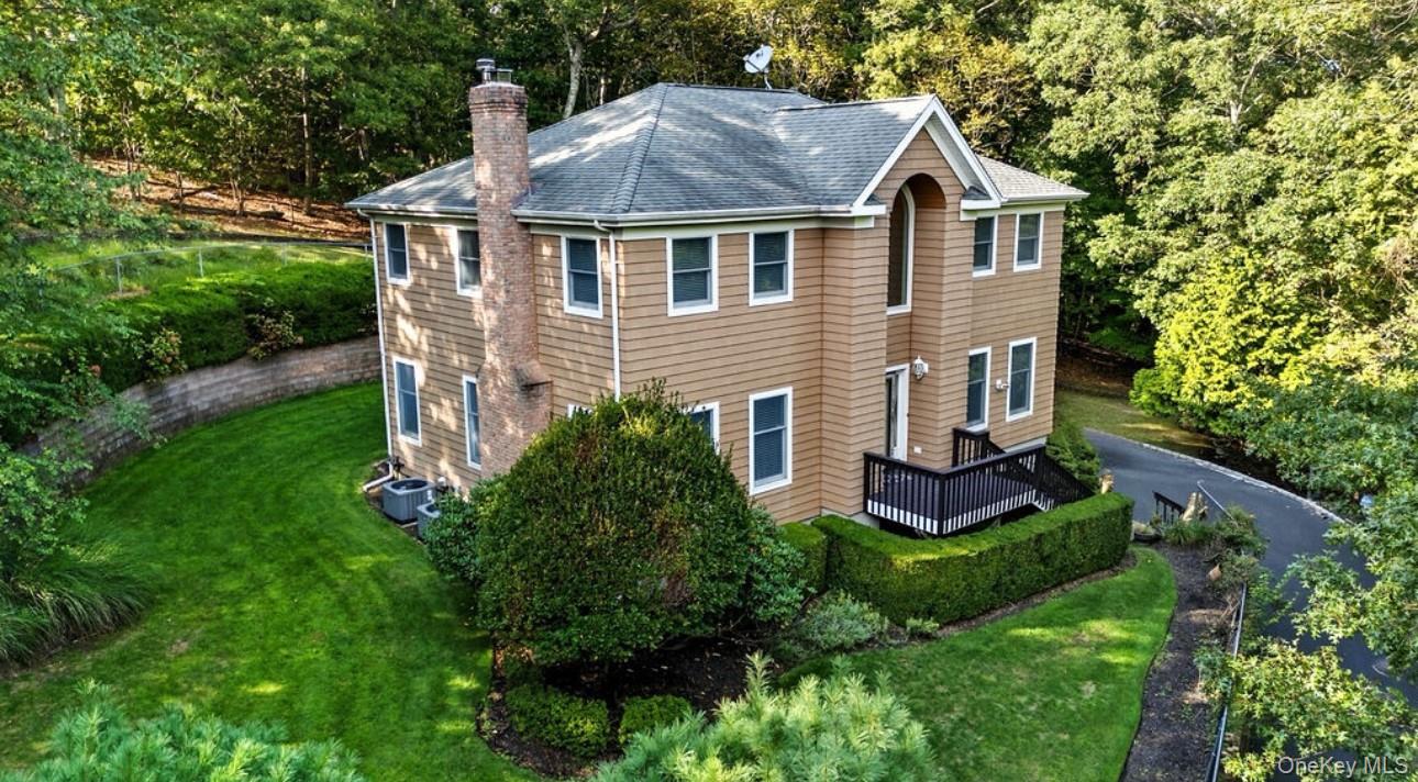 Beautifully Maintained Colonial in a Picturesque Setting!Welcome home to this stunning, sun-filled Colonial nestled on a serene and private .93-acre lot, just blocks from the water. Step into a bright and airy foyer that leads to a spacious living room with a cozy fireplace, perfect for relaxing evenings. The home features a formal dining room and a large eat-in kitchen with a center islandâ€”ideal for entertaining and everyday living.Upstairs, you&rsquo;ll find a generous primary suite complete with a private en-suite bathroom featuring a soaking tub, walk-in shower, and ample closet space. Three additional well-sized bedrooms share a full hall bath, offering comfort and flexibility for family or guests.The lower level includes access to a two-car attached garage, a large storage room, utility area, and a walk-in closetâ€”plenty of space for all your storage needs.Outside, enjoy your own private oasis surrounded by nature, with nearly an acre of lush landscape to call your ownâ€”all just minutes from the waterfront.Don&rsquo;t miss this rare opportunity to own a beautifully cared-for home in an unbeatable location!