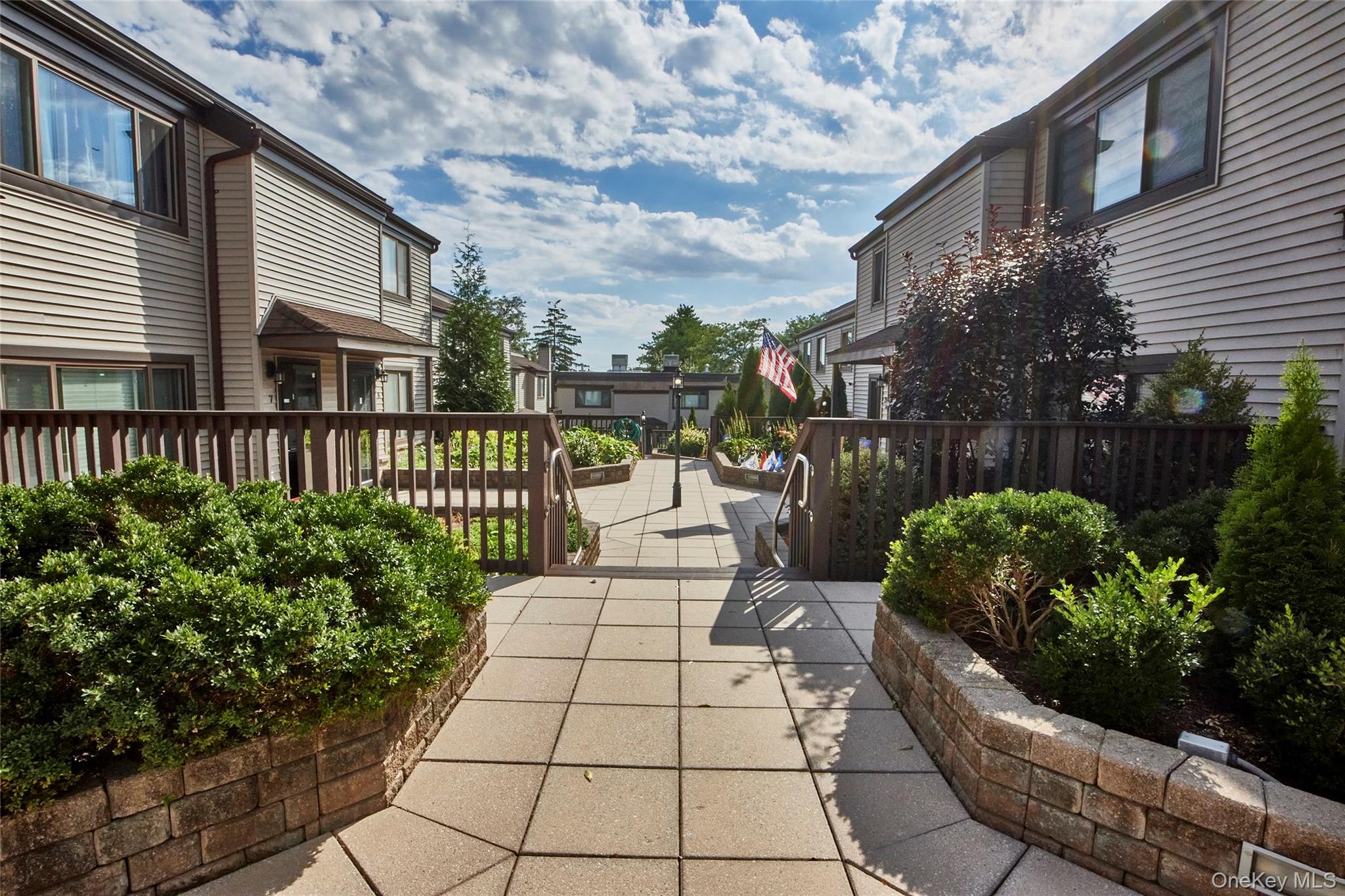 Welcome to Takara Condominium and to Unit 4, where comfort and convenience await! This charming townhome is designed for effortless living, nestled in a community with a true neighborhood feel. The spacious living room welcomes you with a large picture window, leading to a dining area featuring sliding glass doors to your private patioâ€”perfect for enjoying peaceful views. The kitchen has updated cabinetry, backsplash, counters, dishwasher, and microwave. Just off the kitchen is a conveniently located powder room.Upstairs, relax in your sizable primary bedroom with an en-suite bath and walk-in closet. Two additional bedrooms and a full hall bath with laundry complete the second floor. Enjoy the ease of an assigned two-car garage with an automatic door, central air conditioning for year-round comfort, and baseboard heating for those chilly days.With easy access to transportation, shopping, and dining, plus common outdoor spaces and a pet-friendly policy, Unit 4 is the ideal low-maintenance home for those seeking tranquility and convenience.