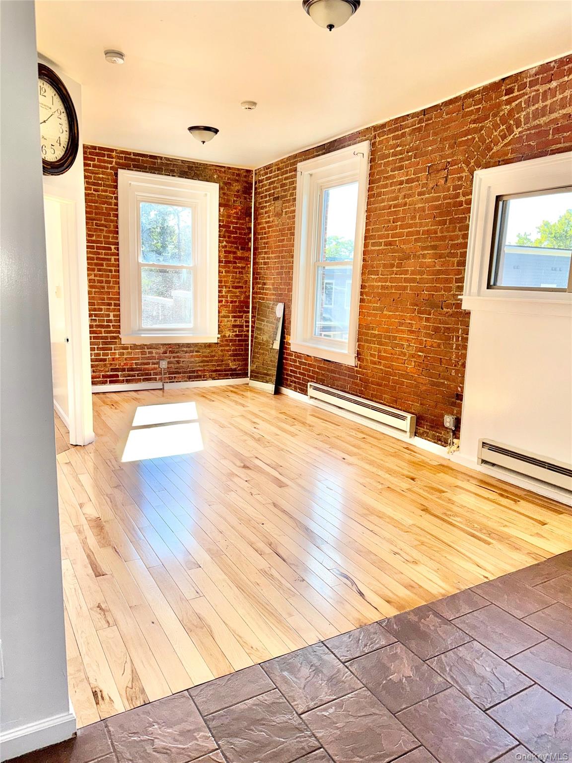 For Rent 2657 E Main St Apt 2 Second-floor apartment offering modern charm with exposed brick walls, high ceilings, and beautiful hardwood floors. Enjoy an open-concept layout with a sleek kitchen featuring stainless steel appliances and granite countertops. Oversized windows bring in abundant natural light, creating a bright and airy feel. Conveniently located in the heart of Wappingers Falls, just steps from dining, shopping, and commuter routes.