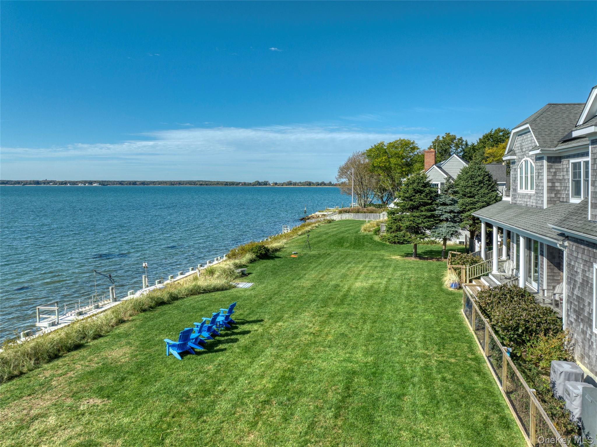 STUNNING BAYFRONT Local Art Filled Home, with Mooring (Boat Lovers Welcome), Private BAY Beach and 5 min WALK to VILLAGE!Over 4500 sqft of immaculate contemporary, gorgeous furnishings with a local artist&rsquo;s own artwork make this home perfect for your own enjoyment and summer entertainment. The only bayfront rental fully set up for your boating and swimming needs. Light, bright and mint, 4 super spacious bedrooms, 4 baths (200-degree water views), tons of additional family entertainment and hangout rooms (indoor and outdoor), double outdoor shower, gardens filled with blooms and a lot more. Beautiful classic lines and architectural details throughout. Walls of windows and high ceilings showcase stunning sunsets year around over Orient Harbor and beyond. Gourmet kitchen, open floor plan with glass doors to outdoor dining area, waterside lawn, two decks and stairs to the water makes this a perfect opportunity for entertaining and family relaxation - walk down your steps to swim, paddleboard, boat or fish. Electric winch, tender, close mooring. Bring your own or easily rent a boat from one of the local marinas. Rental includes a gas grill, 2 boat moorings and nearby association sandy beach. This very well-appointed home includes an open fireplace, perfect for an extended stay throughout the fall and beyond in an idyllic location that beckons peace and relaxation surrounded by nature and luxury. June $20, 000; July $40, 000; Aug $50, 000; Sept $30, 000. Permit# 0595