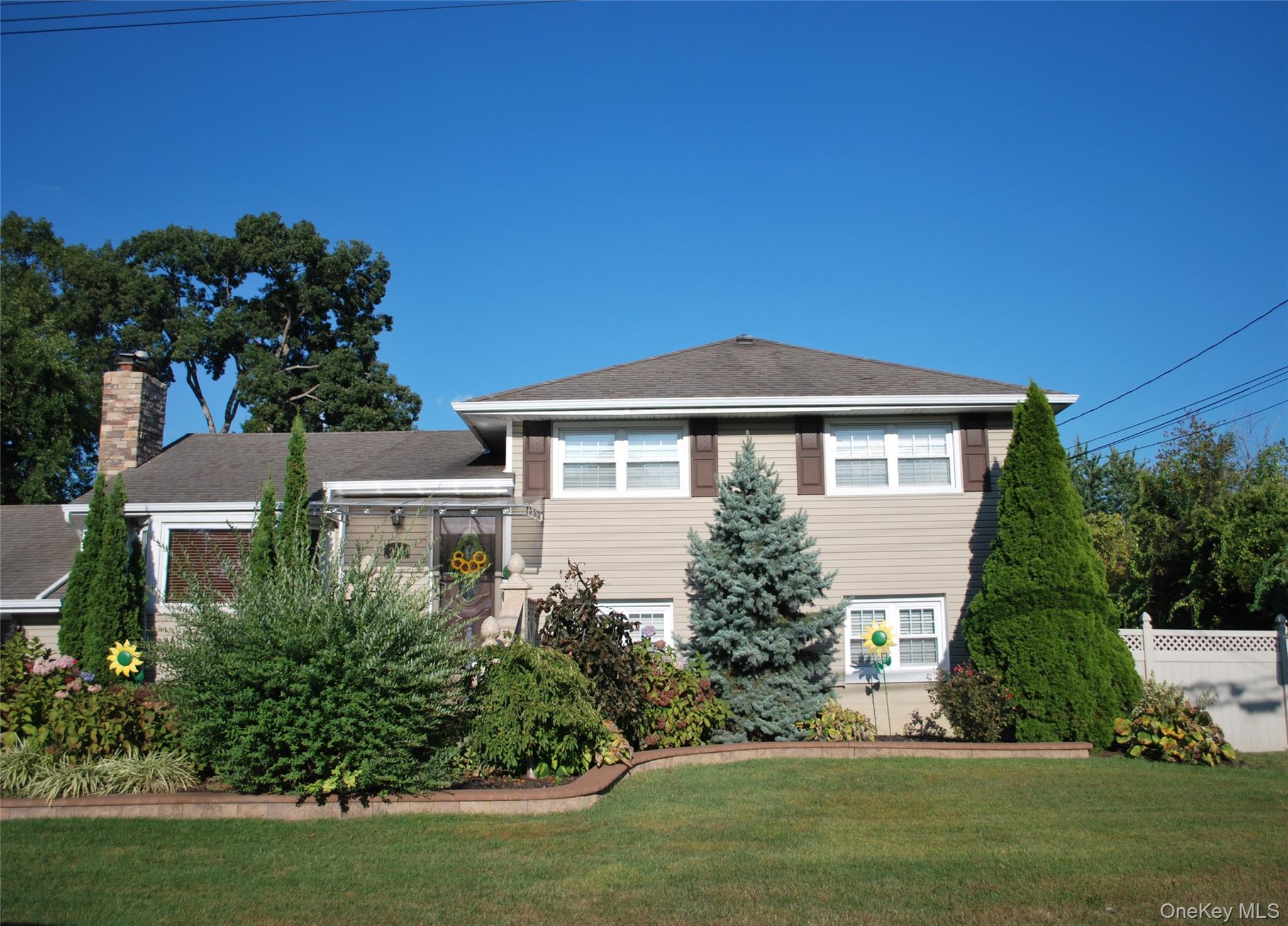 Welcome to this beautifully maintained 4 Bedroom Split Level-style home in Deer Park! Situated on a spacious lot, this residence offers a perfect blend of comfort, convenience, and outdoor enjoyment. The main level features hardwood floors throughout, with an open-concept layout ideal for both relaxation and entertaining. Youâ€™ll find a generous living room, a dining area, and a kitchen on the main floor with sliding glass doors leading to a large backyard. Enjoy your own retreat with a beautifully maintained inground pool, patio, garden perfect for leisure or entertaining. This home also features central air conditioning, a 2-car attached garage, a bricked paved driveway, and proximity to local shopping, dining, and public transportation.Come discover the comfort, convenience, and charm this Deer Park home has to offer.
