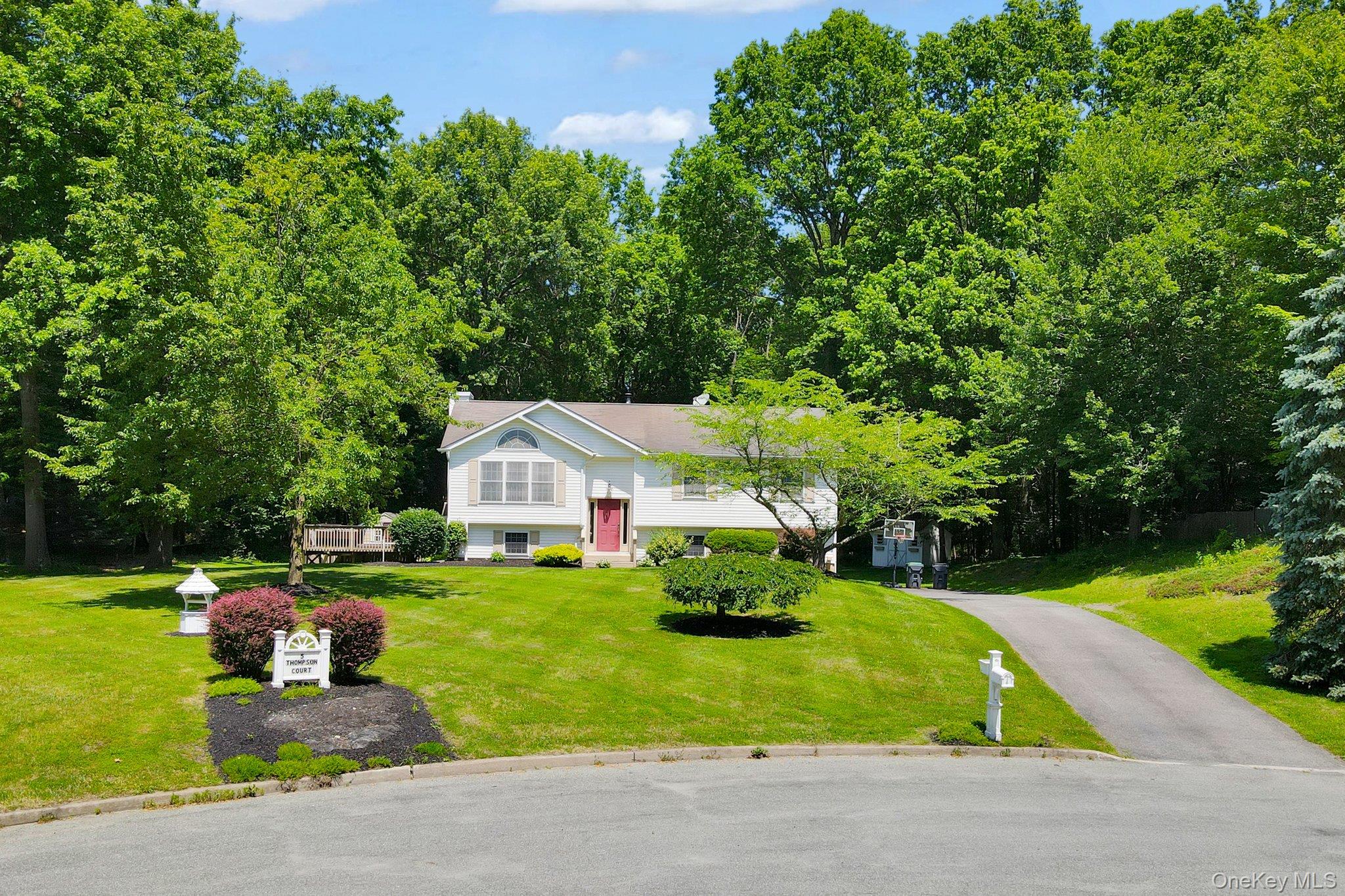 Move right in to this beautiful custom built raised ranch with 4 bedrooms and 2 1/2 baths built by the original owner on 1.3 acres of manicured gardens and parklike land on a private cul-de-sac. Large 2 tier deck with a hot tub and an above ground pool perfect for outdoor enjoyment and entertaining. All this in the highly sought after Goshen School District. The first floor offers an open floor plan kitchen with stainless steel appliances, living room and dining room with cathedral ceilings. Main bedroom with full ceramic tile bath, 2 additional bedrooms and a second full bath. Hardwood floors, many closets, , central air and a generator. The lower level has a family room, laundry room, 1/2 bath, a large bedroom with sliding doors leading to a beautiful stone patio area and an additional room presently used as a 5th bedroom that can be used as a den/office. Close to parks, restaurants, shopping, major highways and train to NYC.