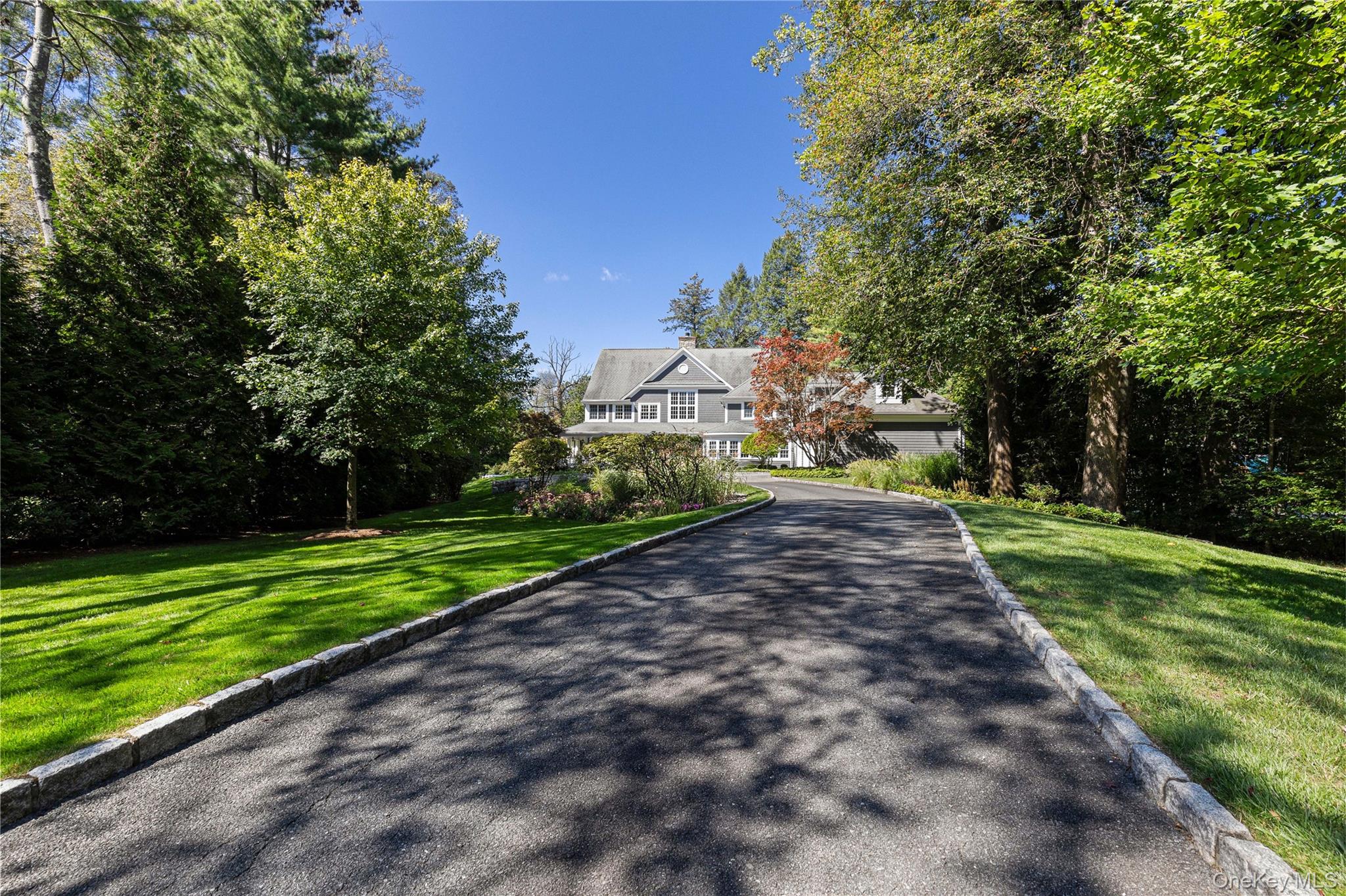 Nestled on 1.5 acres of beautifully landscaped, level grounds in the prestigious Hillandale estate area of Rye Brook, this exceptional newer Colonial exemplifies timeless elegance and modern sophistication. Custom built with the finest craftsmanship, the residence offers 6 bedrooms and 5.1 baths, designed to accommodate todayâ€™s lifestyle with effortless grace. A grand and light-filled interior showcases exquisite architectural details, including custom millwork, refined cabinetry, marble and hardwood flooring, and soaring ceilings. At the heart of the home, a Christopher Peacock kitchen with marble counters, an expansive center island, walk-in pantry, and top-of-the-line appliances creates an unparalleled culinary setting. The stunning primary suite serves as a serene private retreat, complemented by generously scaled secondary bedrooms and thoughtfully designed guest quarters. There are many beautifully appointed rooms for entertaining and a home office to complete this exceptional home. Equally impressive, the exterior enhances the sense of arrival and refined living. A long, meandering driveway leads to a heated courtyard and welcoming front porch, while a three-season room and expansive wraparound deck seamlessly connect the home to its scenic surroundings. The propertyâ€™s setting provides exceptional privacy and tranquility, offering a true retreat from the everyday. Recently and professionally decorated with refined updates, this remarkable home also features ample storage, a three-car attached garage, and a wealth of modern amenities. A rare offering in a coveted estate enclaveâ€”this property is truly one of distinction.
