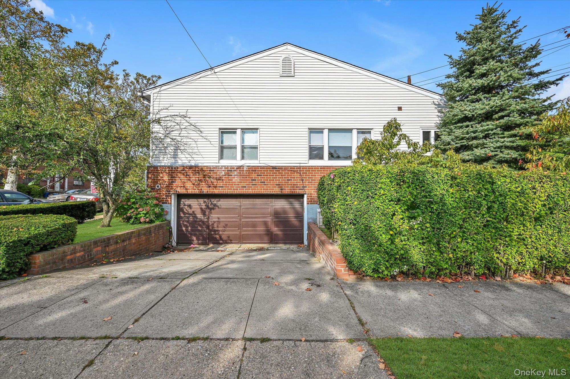 Rare Find! The Only House on the Block! Custom Built Hi-Ranch in Move-In Condition in Prime Whitestone. The Main Level Offers an Eat-In Kitchen, Living Room/Dining Room Combination, Three Bedrooms, and Two Full Bathrooms. The Primary Bedroom Offers a Walk-In Closet and En-Suite Bathroom. The Lower Level Features a Two Car Garage, a Large Recreation Room, Summer Kitchen, Half Bathroom, Boiler Room, and Closets Galore. The Semi-Finished Pull Down Attic Perfect for Additional Storage. Two Zone Gas Insta Hot Water Heating System. Located in Close Proximity to Schools, Shops, and Loads of Transportation.