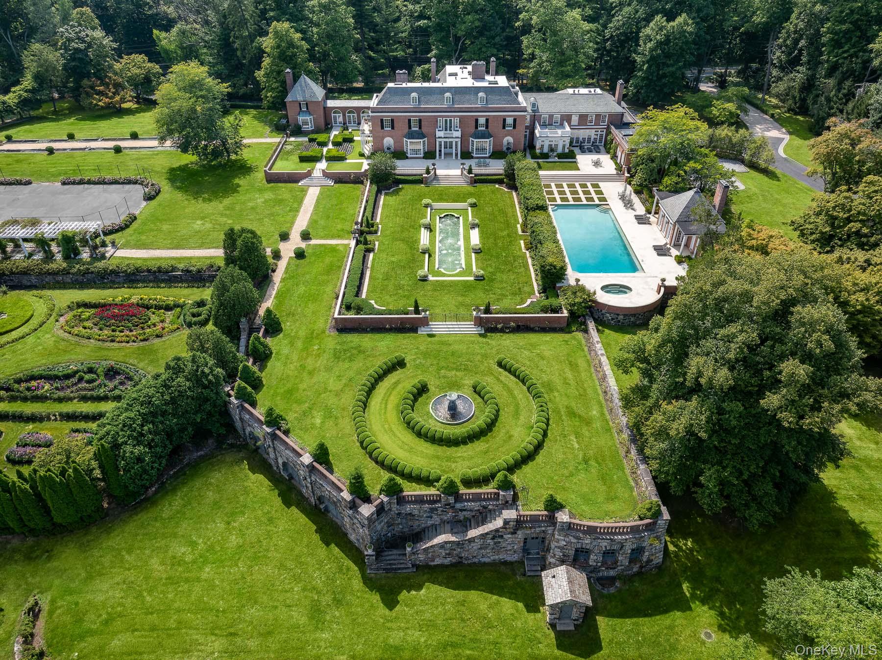 Symbolically built for the founding family of Purchase, this iconic estate presents an exclusive opportunity to acquire one of the most significant and unique New York residential real estate properties available in recent years. The epitome of a true suburban compound, this grand residence is uniquely situated within quick reach of New York City, water and golf amenities, and all means of domestic and international travel, presenting a priceless blend of lifestyle and convenience truly unmatched by any other property in the surrounding areas, including Westchester and Greenwich. Sitting majestically behind the gated approach to 41+ acres of enchanting and masterfully enhanced property, the 14, 000+ square foot main house, rich in character and history, has been entirely and meticulously renovated to the highest caliber and with the most timeless, elegant and beautiful finishes. Creating a true compound landscape, the main house is completed by two additional guest residences, a multi purpose â€œhangerâ€ and a free standing pool house -- all not included in square footage -- effortlessly enhancing every conceivable amenity and entertainment possibility. A thoughtful and artistic blend of design, function, beauty and grandeur, the â€œArrow Hillâ€ estate offers an array of both intimate and over sized terraces and reception lawns, perfect for events both large and small. Adorning these outdoor spaces you find the collection of exquisite garden statuary, elegant fountains, serenely crafted babbling brooks, ponds, and waterfalls as well as picturesque floral and english gardens, creating an atmospheric masterpiece of natural beauty. Venture along this breathtaking oasis down the inviting pebbled pathways complimented by ornamental trellis and curved allee of specimen trees and vine canopies. Living art abounds in the masterful placement of incredibly crafted koi ponds, reflecting gardens and an enormous greenhouse. Sporting and adventure seekers will enjoy the resort size pool, outdoor tennis court with spectator/entertaining terrace, indoor sports court, full gym, numerous trails and the incredible â€œcatacombsâ€. The extensive acreage of additional picturesque level property and trails that lie beyond these magnificent spaces provides the unique opportunity for possible equestrian facilities or any other conceivable enjoyment, collection or opportunity imaginable, masterfully adding to, and without compromising, the integrity, beauty and privacy of this majestic home. A true work of art, and until now, virtually an unattainable blend of grand suburban compound living, right within the midst of the incomparable city life of iconic Manhattan.