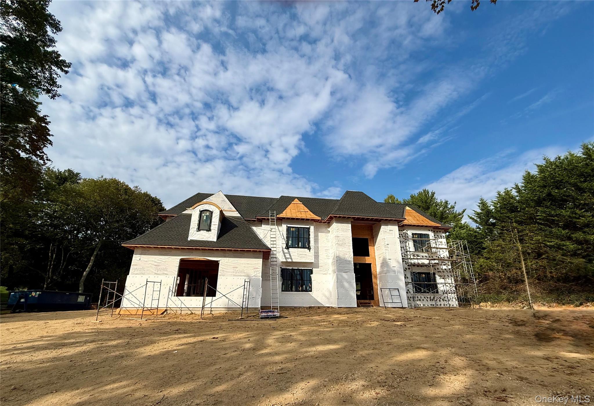 Welcome to this brand-new, masterfully designed estate by Piazza Custom Builders, nestled on a tranquil, tree-lined street in the heart of Dix Hills. Perfectly positioned on a flat, full-acre property, this new construction residence offers nearly 6, 000 sq ft of thoughtfully designed living space featuring 6 bedrooms, 5.5 baths, and 10â€™ ceilings throughout.A grand 22â€™ front-to-back entry foyer leads to an open floor plan with formal living and dining rooms, a sunlit great room with fireplace, and a chefâ€™s kitchen with custom white oak cabinetry, premium Thermador appliances, oversized island, and butlerâ€™s pantry. Expansive Marvin windows throughout flood the home with natural light while showcasing the fine craftsmanship. An added bonus is the addition of grand accordion doors that unfold to a beautiful backyard pavilion, where indoor comfort meets outdoor elegance for effortless entertaining and year round enjoyment.The first-floor guest suite with private entrance is ideal for visitors or extended family. A mudroom with built-in storage is conveniently located off the attached 3-car garage. Upstairs, a secluded and luxurious primary suite features a spa-like bath with radiant heat. Two additional bedrooms offer private en-suites, while two more share a connected full bath. A second-floor laundry room adds convenience.Additionally, the home includes a full walk-out basement with grand stadium steps, 10&rsquo; ceilings, and 2, 800 sq. ft of potentially finished space, plus a full-height attic with another 2, 000 sq ft of abundant storage or future expansion. The possibilities are endless!As this is new construction, buyers are still in the building phase where certain aspects may be customized to fit their vision, so don&rsquo;t delay. What sets this home apart is its exceptional craftsmanship, layout, and finishes combined with a fine sense for detail. Capture this rare opportunity to own a brand-new, luxury estate in one of Dix Hillsâ€™ most desirable locations.