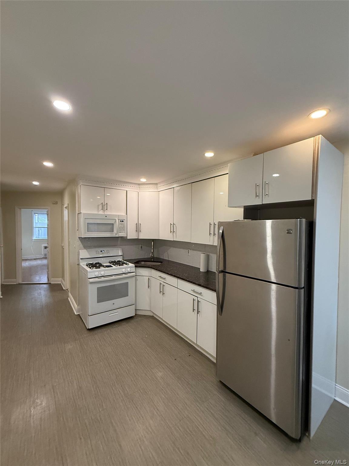 Spacious walk-in one-bedroom apartment featuring a bright, welcoming living area and a convenient eat-in kitchen. The unit is clean, cozy, and well-maintained, offering a comfortable layout that makes the most of every space. An inviting entry leads to a generous living room, with plenty of natural light and smooth flooring throughout. The kitchen provides room for casual dining and daily meal prep, ideal for creating home-cooked meals. The bedroom is quietly situated, offering a restful retreat with ample closet storage. Located close to the B46, B7, and B6 bus routes for easy commuting and quick access to local amenities, this apartment combines practicality with a pleasant, homey feel.