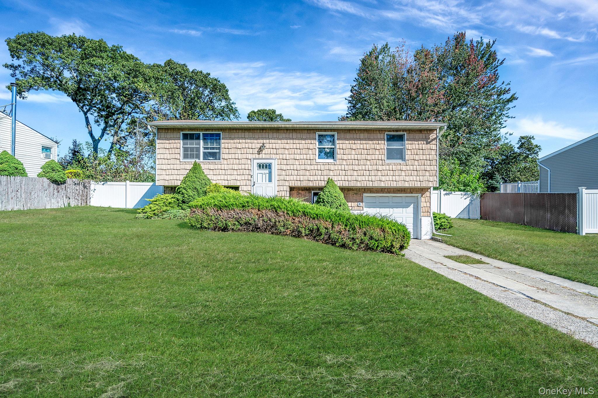 Spacious 4 bedroom, 1.5 bath Hi Ranch located in the heart of Selden within the Middle Country School District featuring gas heat. This home offers an eat in kitchen, dining room, living room, 1 car garage, and a lower level with sliding doors leading to the backyard. The expansive yard provides endless possibilities to create your perfect outdoor retreat. Brand new water heater. Ready for renovation, bring your tools and imagination to transform this property into the home of your dreams. Sold as-is.