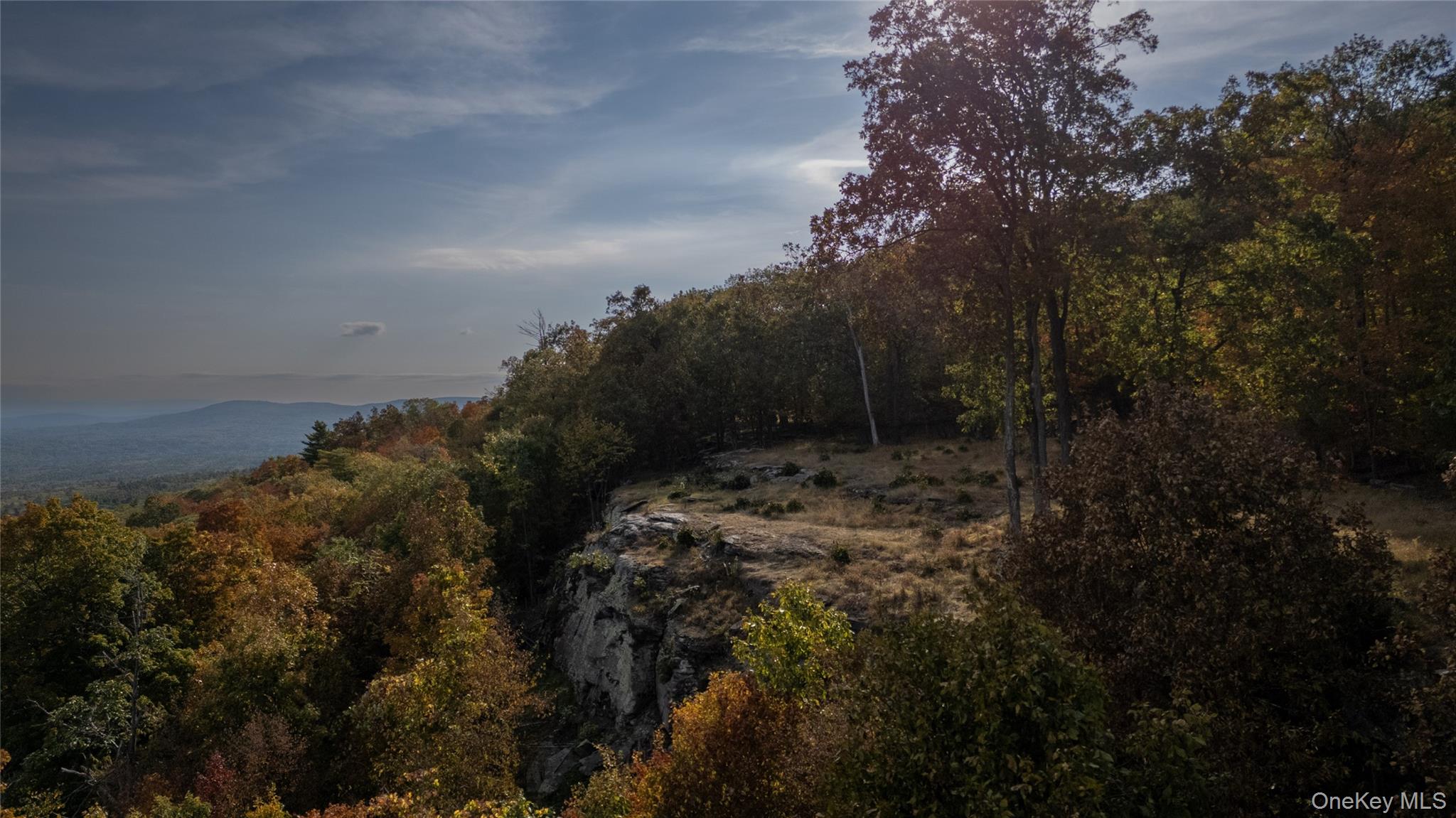 Discover a rare opportunity to own 5.45 acres atop one of Woodstock&rsquo;s most coveted locations. This private, east-facing lot offers panoramic views that stretch endlessly over the Catskill Mountains, providing an awe-inspiring backdrop for your dream home. With the space and natural beauty to build a sleek, modern estate, this land is the perfect canvas for a luxury retreat.Surrounded by the tranquil, wooded mountaintop, you&rsquo;ll enjoy ultimate privacy while still being just minutes from Woodstock&rsquo;s vibrant arts and culture scene. The property is cleared and ready for construction, with Board of Health approval for a 4-bedroom, 3000 sqft home. A winding private drive, which is part of the HOA, ensures seclusion, with a security system in place for added peace of mind.Located on the prestigious Raycliffe Drive, this land not only boasts commanding views but also grants deeded access to a private tennis court, offering both luxury and convenience. With its unique rock ledge feature, the property&rsquo;s rugged charm sets the stage for a home that feels perfectly at one with the landscape.This is more than just a lotâ€”it&rsquo;s an extraordinary canvas to build a legacy home. The opportunity to create a mountaintop paradise in Woodstock is rare, and this land offers it all: breathtaking views, ultimate privacy, and the chance to live in one of the most desirable locations in the area. Your future home awaits.*This property is located within a private, security-monitored community. All showings must be scheduled in advance and will be personally accompanied by the listing agent. Unaccompanied visits and drive-bys are strictly prohibited. No exceptions.