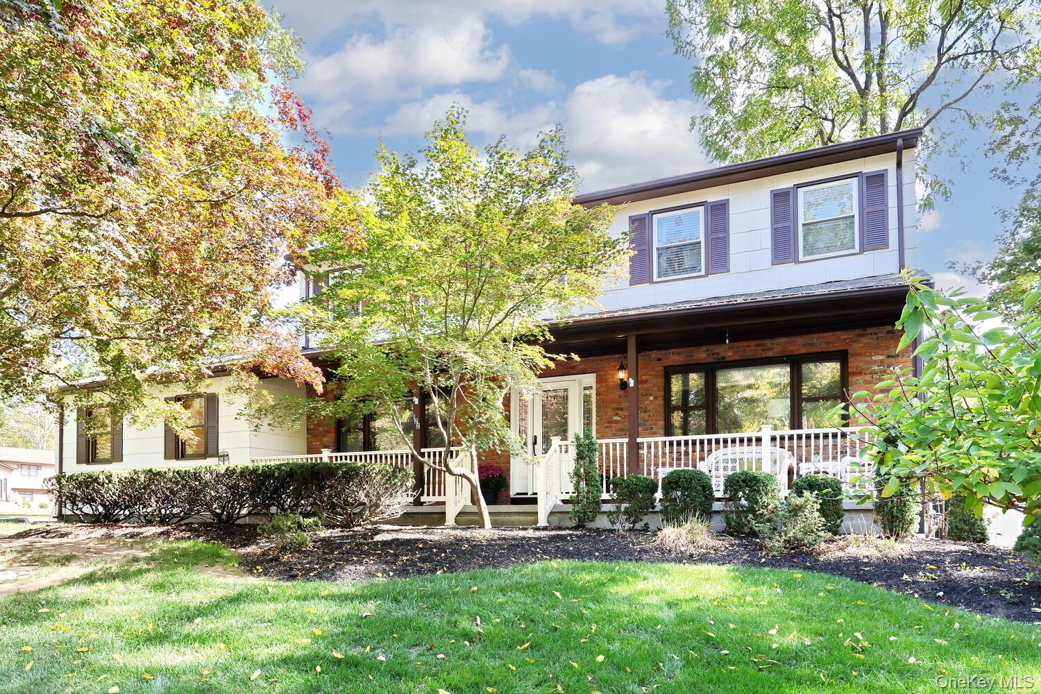 Classic Center Hall Colonial with timeless curb appeal and a welcoming front porch, ideally located in one of Clarkstownâ€™s most desirable neighborhoods. This beautifully maintained 4-bedroom, 2.5-bath home features hardwood floors throughout both levels and a layout that perfectly blends comfort, style, and functionality. The bright, updated kitchen with center island opens seamlessly to the spacious family room featuring a gas fireplace and custom built-in shelving. Formal dining and living rooms provide ideal spaces for entertaining or everyday living. A sun-filled three-season room off the back of the home overlooks a flat, fully fenced backyard with a patio and mature landscaping for complete privacy. Upstairs, all bedrooms are generously sized, including a comfortable primary suite. Additional highlights include a new roof (2024), new front door (2018), all interior doors replaced, a main-level laundry room, and a convenient laundry chute from an upstairs bedroom to the closet just outside the laundry room. Thereâ€™s also a large unfinished basement offering excellent storage or potential for future expansion. The property includes a two-car garage and large driveway. Located within the award-winning Clarkstown South School District, this home has been lovingly cared for and offers space, quality, and a prime New City location â€” truly a must-see!