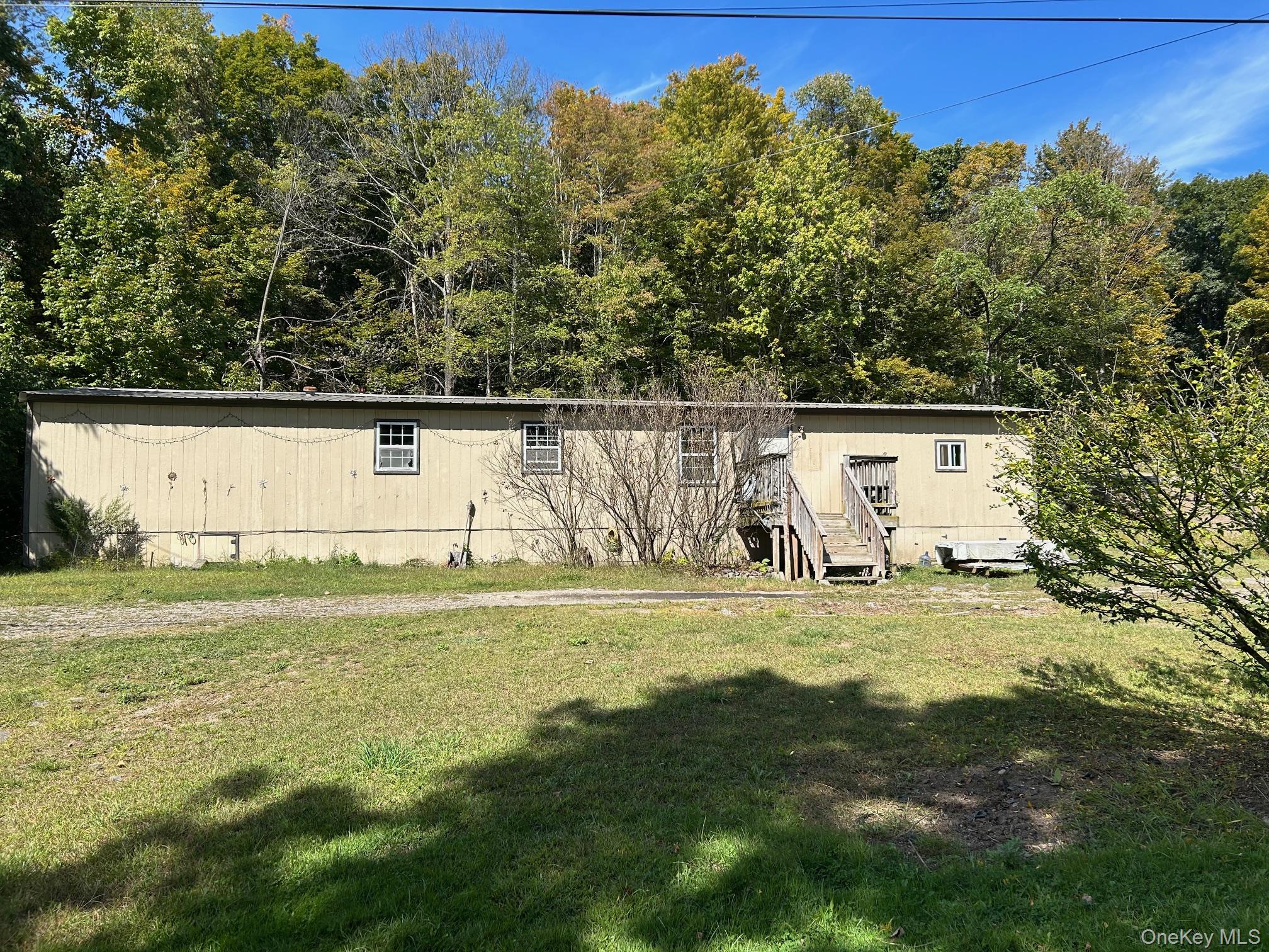 AFFORDABLE manufactured home on .6 acres with a metal roof. Needs some TLC. Well, septic, electric all onsite. Live in while you renovate, renovate and move in,  remove and build your dream home. This could also be a good rental income property with some TLC. The possibilities are endless. Any reasonable offer considered. Get your piece of Kerhonkson. Property being sold as is.