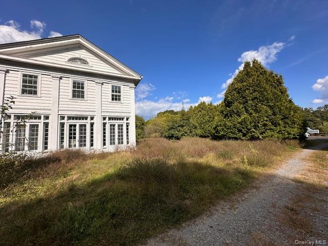 Check out this majestic six-bedroom, six-bathroom colonial with five fireplaces that now sits on fifteen acres. It could now be transformed into a Bed and Breakfast. This stunning true center hall colonial has front and rear doors with a beautiful archway. The formal dining room has a glass built in cabinets, a fireplace, and a hidden floor to ceiling safe. Most of the house has hardwood floors throughout, original detailed millwork, and plaster walls. The well-appointed rooms have tall ceilings large windows and French doors give the interior rooms lots of light. The living room has original glass built in bookcases and a fireplace. The study has oak built in bookcases and the full bathroom has marble and tile. The enclosed porch off the living room runs the width of the house and has the original windows and doors. The primary bedroom is on the second floor with an en-suite full bathroom, fireplace, walk in closet and dressing room. There are two additional full bathrooms that service the other four bedrooms. One other bedroom has a private entry, dressing area and fireplace. The unfinished lower level has tremendous potential. It has several rooms, a wine cellar, cedar closet and another floor to ceiling safe. There is a two-story guest wing with a fireplace, separate entrance, kitchen, three bedrooms and three bathrooms. Ideal for guests, in-laws or for use as a rental property. There is a 1500 square foot barn and three car detached garage.