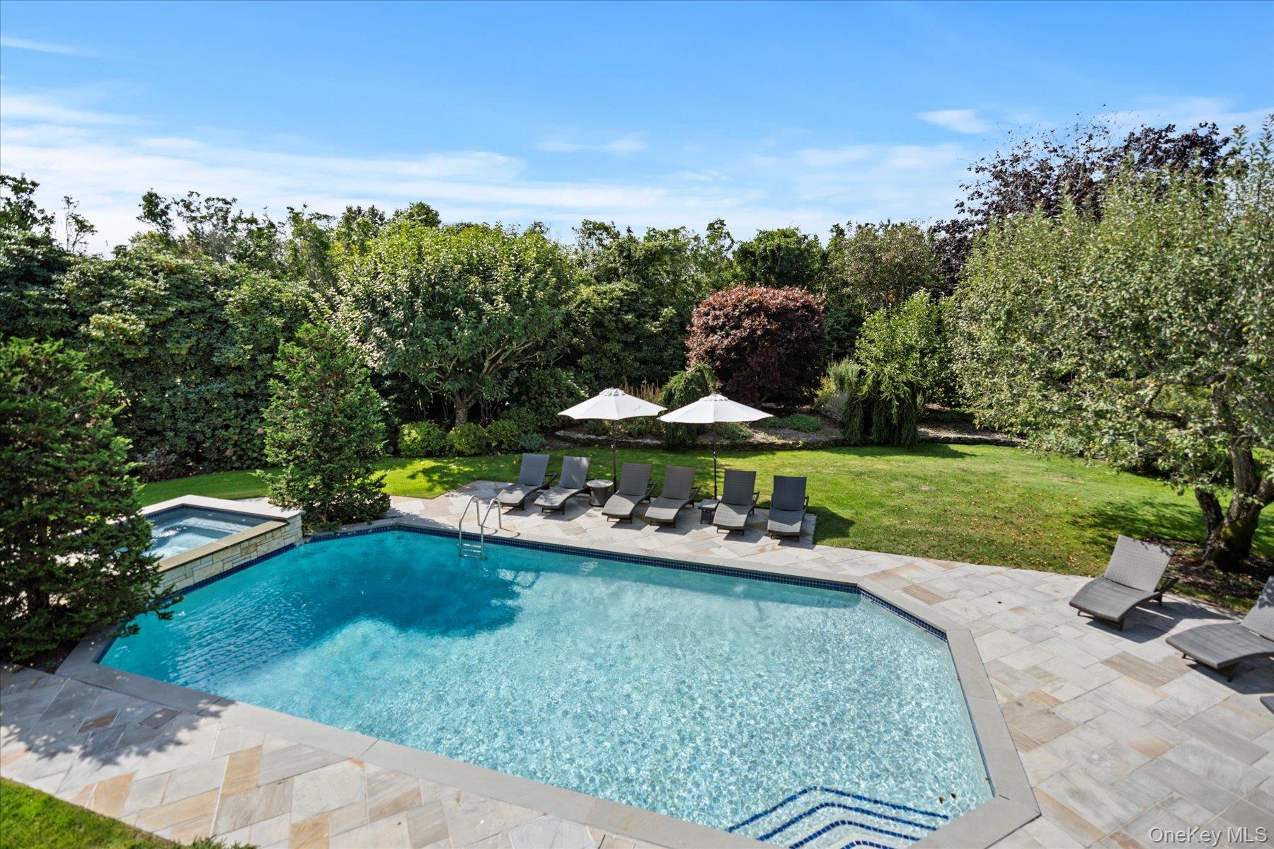 Southampton Village - Elegantly Renovated Carriage HouseLocated in the heart of Southampton Village, 231 Flying Point Road is set on 1.4 private and specimen tree lined gated acres. Thoughtful and sophisticated detail are displayed inside and out. Recently renovated and professionally decorated, it offers a livable interior design & atmosphere to provide the most comfortable lifestyle for the most discerning clientele. Located moments from America&rsquo;s most desirable white, sandy, ocean beaches, this home stands out amongst the rest. Five generously sized bedrooms throughout the residence all complete with private baths. A potential 6th bedroom/office with private bath is available on the main level. The primary bedroom welcomes the head of the household with fireplace and private balcony overlooking the grounds. The main living areas include 2 wings, with separate living rooms for entertaining guests while others relax and unwind in the alternate room both include fireplaces as a focal point. Other notable areas include library, bar, formal dining and finished lower level with media area, game room and gym. The grounds include a private, gated, long white pebble driveway, a specimen apple orchard, outdoor patios, heated Gunite pool and spa on lushly landscaped property. All located within minutes of the world famous attractions located in the coveted village of Southampton. Exclusively listed.