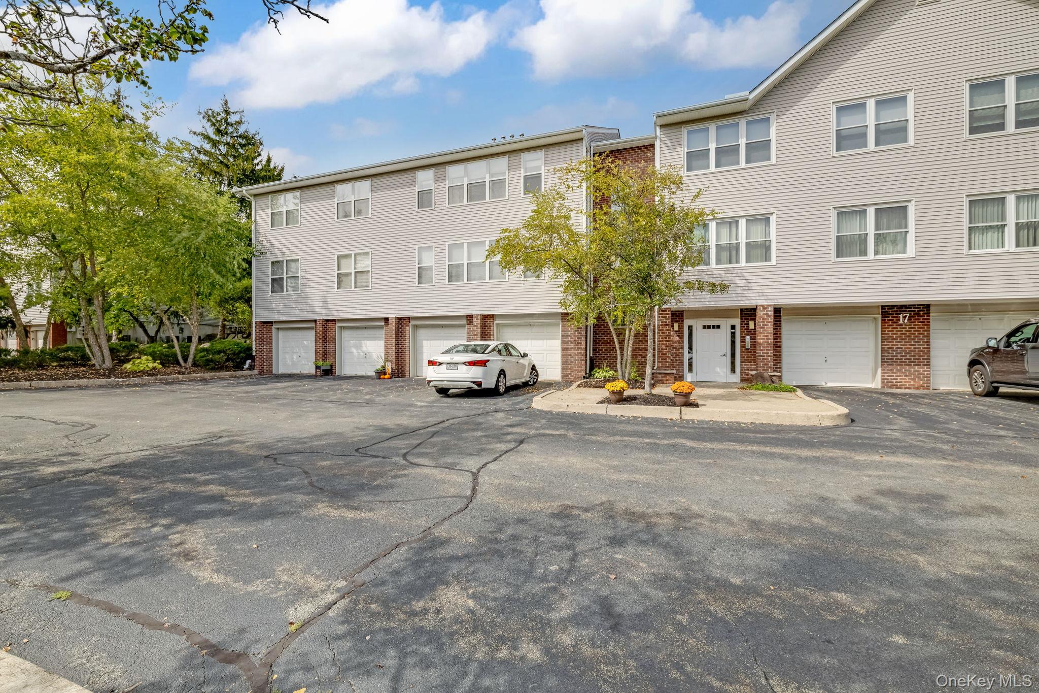 This bright and spacious third-floor corner condo in the sought-after Deer Run community offers two bedrooms and two full baths with an open floor plan ideal for both everyday living and entertaining. Sunlight streams through a wall of windows into the combined living and dining area, while the kitchen provides abundant cabinetry and a generous pantry. The primary suite features a large walk-in closet and a private en-suite bath, and the second bedroom is equally roomy and filled with natural light. A separate laundry room adds convenience, and the oversized two-car stacked garage offers exceptional space for storage, hobbies, or a workshop. Residents enjoy access to a clubhouse with a full kitchen for private gatherings as well as a swimming pool and tennis and pickleball courts, all set within beautifully maintained grounds. Perfectly located near shopping, dining, parks, and schools, and just minutes from Metro-North trains, major highways, and bus routes, this move-in-ready home provides the opportunity to personalize while enjoying a vibrant, amenity-rich lifestyle.