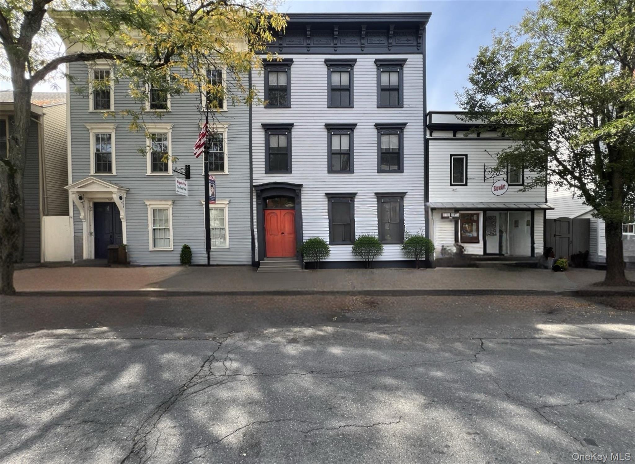 ON HUDSON&rsquo;s HISTORIC PROPRIETORS ROW On Warren Street&rsquo;s historic Proprietors Row, this 1800s Federal gem has been reborn as a modern, two-unit residence that balances historic elegance with today&rsquo;s lifestyle. It&rsquo;s rare to find a property this pristine from top to bottom, with income potential, off-street parking, and fenced in yard-all just steps from Hudson&rsquo;s vibrant shops, restaurants, and galleries.Inside, high ceilings and oversized windows a throughout as wide halls open to generously scaled rooms that create a sense of grandeur, while thoughtful updates blend 21st-century convenience with timeless style. Beautiful hardwood floors, sliding barn doors, designer hardware, and sleek finishes bring a chic sensibility to the home&rsquo;s character.A gracious staircase leads to a light-filled duplex with its main level living spaces with gas-fireplaces,  open kitchen and yard access. Two bedrooms, including a grand primary en-suite with its sun-lit bath, along with a second bedroom, additional full bath, laundry and wide central sitting hall complete the upper floor. The garden-level is a sophisticated one-bedroom, with a stone-walled gas fireplace, tiled bath, and open kitchen with direct access to the sunlit south yard. Being street level, also ideal for shop or business. OPTIONS! With central air, individually metered units, and the flexibility to live stylishly in one apartment while renting the other-or to easily convert the whole house back into a single- residence-this property offers a rare opportunity in one of the Hudson Valley&rsquo;s most dynamic markets