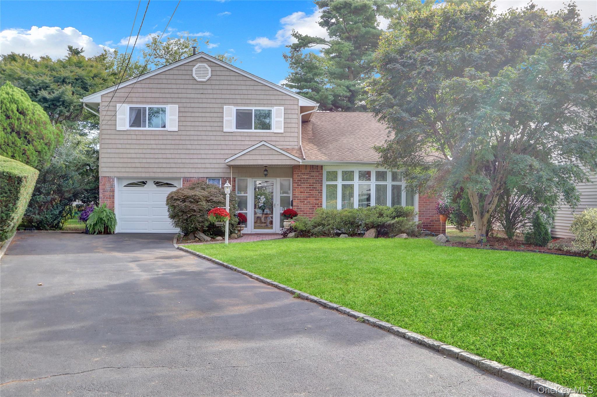 Welcome to this Roslyn gem, perfectly situated on a desirable mid-block location. From the moment you step inside, youâ€™ll feel the inviting flow designed for both everyday living and entertaining. The main level features a spacious den, home office/bedroom, guest bathroom, and an open-concept family room and dining room. The kitchen overlooks a totally private, flat backyard with lush greenery and a patioâ€”ideal for summer gatherings.Upstairs offers a serene primary suite with its own bath, two additional bedrooms, and a newly renovated full hall bathroom with double sinks and a tub. The lower level includes laundry and a flexible space perfect for a playroom, gym, or media room. Additional highlights: Membership to the coveted East Hills Park & Pool Included with this home. Central Air Conditioning. Convenient access to train stations, highways, schools, shopping, and dining. This home truly has it allâ€”space, comfort, and location. Donâ€™t miss it!
