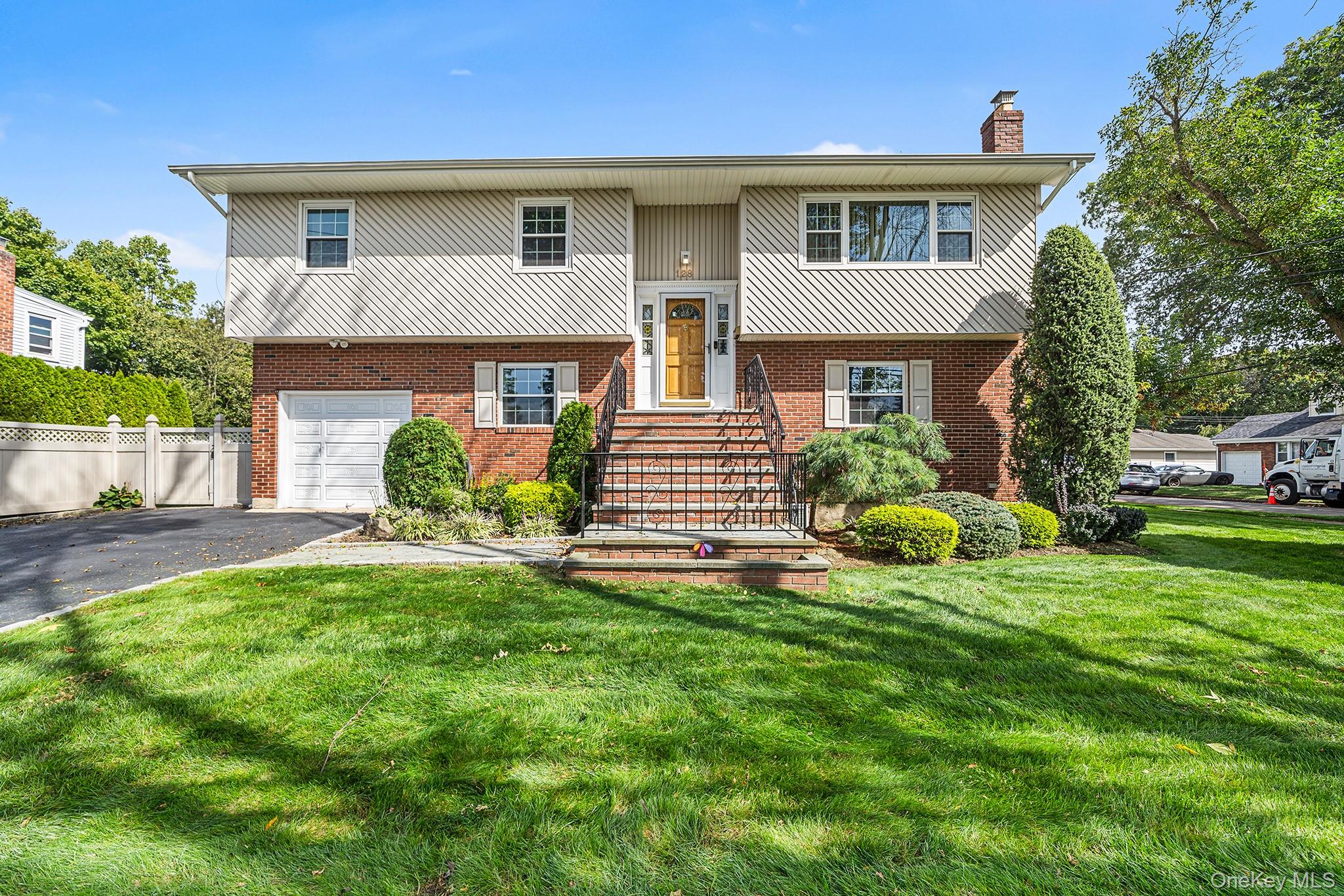 A rare opportunity to own a High Ranch with a full basement featuring an outside entrance, 128 N Windhorst Ave offers space, flexibility, and a sought-after location in Bethpage. The classic exterior with its welcoming front presence and well-kept property sets the tone for this versatile home. Inside, youâ€™ll find 5 bedrooms and 4 full bathrooms, including a private en-suite primary. Hardwood floors grace the second-floor bedrooms and main living areas, while the first floor and basement feature primarily engineered flooring for durability and style. The open living room flows seamlessly into the dining area and kitchen. With a full basement and separate entrance, this home presents an ideal setup for a potential mother/daughter arrangement with proper permits. Laundry is conveniently located in the basement. The property includes a fully fenced backyard with a patioâ€”perfect for outdoor gatherings and relaxation. Enjoy being moments from Bethpage town center, schools, shopping, dining, and public transportation. Offering both comfort and convenience, this spacious home is ready for its next chapter.