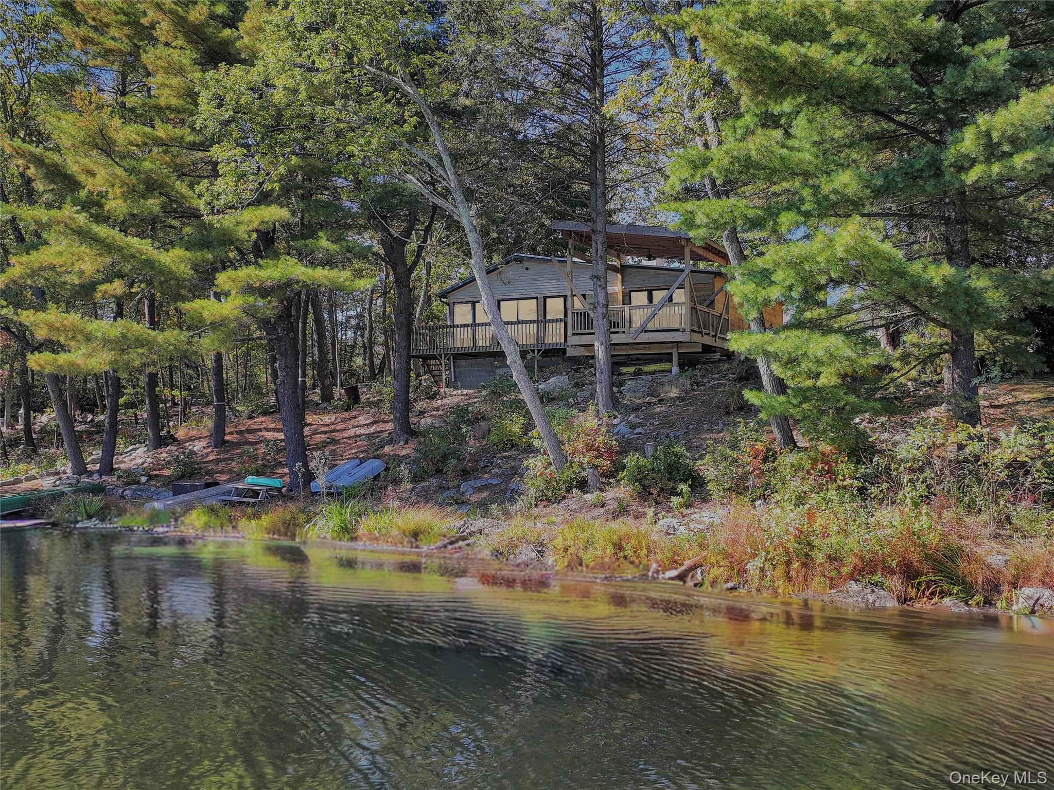 Escape to Nature on Hawthorne LakeDiscover lakeside serenity just 90 minutes from NYC in this beautifully renovated ranch on scenic Hawthorne Lake, tucked within Orange County. Whether you&rsquo;re seeking a peaceful retreat, an income-producing Airbnb, or a year-round lakefront home, 42 Raymond Drive offers the perfect mix of tranquility and opportunity.Enjoy lake rights to fish, swim, or paddle your kayak across calm waters right from your backyard. Relax on your private deck as the sunlight dances on the lake, surrounded by mature trees and peaceful woodland views.Inside, an open-concept layout welcomes you with natural light and picturesque water views. The updated kitchen features Quartz countertops and new stainless-steel appliances. Ideal for entertaining or cozy weekends in. With a new furnace, hot water heater, and central air, this home is completely move-in ready.The primary bedroom features dual closets, while two additional bedrooms with hardwood floors provide plenty of space for guests. A modern bathroom completes this charming retreat.Located just a 2-minute walk to Huckleberry Ridge State Forest, enjoy endless outdoor recreation - hunting, hiking, camping, skiing, and exploring all four seasons.Highlights:Lake rights for fishing, swimming & non-motorized boatingCompletely renovated with modern systems & finishes 2022Perfect for Airbnb or weekend getaway.Steps from Huckleberry Ridge State Forest.Only 90 minutes from NYC.Low TaxesEscape, unwind, and invest in your own slice of paradise on Hawthorne Lake. Living begins here.