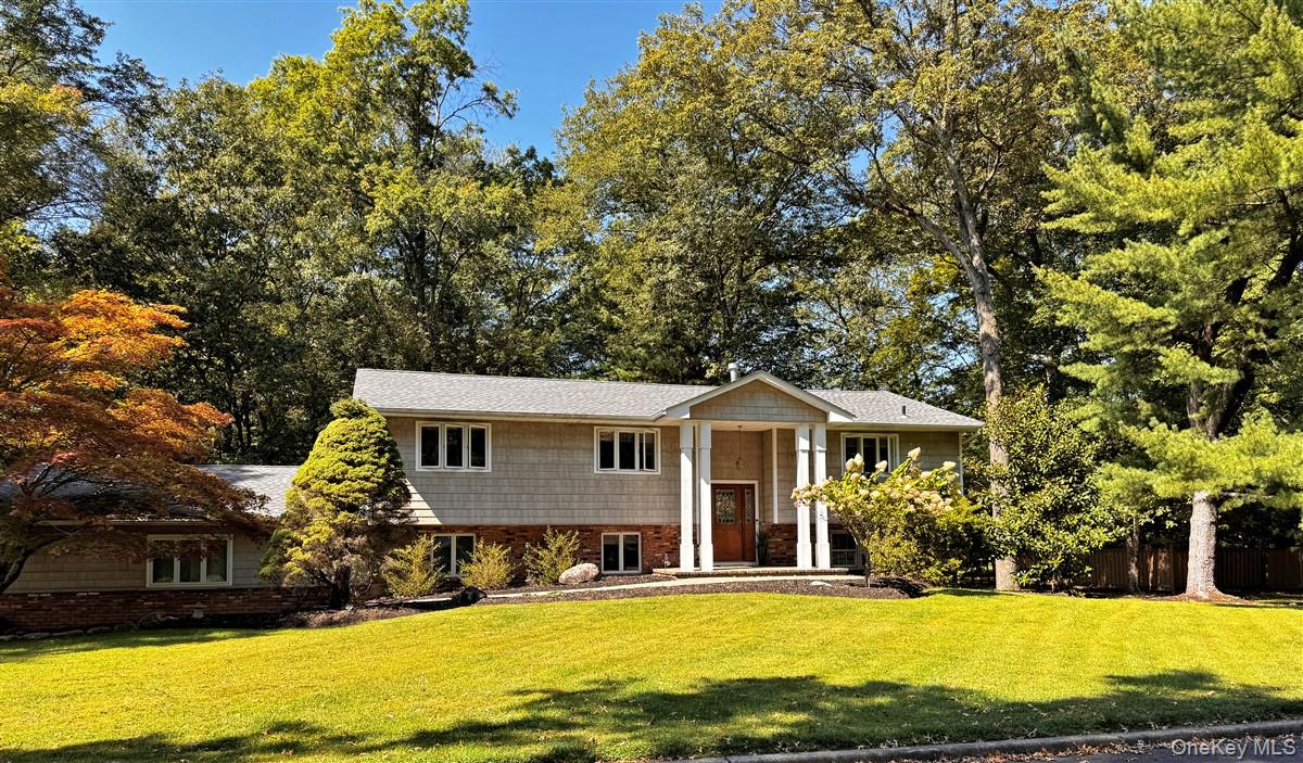 Welcome to this unique and meticulously maintained expanded bi-level home, nestled in one of Northern New City&rsquo;s most sought-after neighborhoods. Set on just under an acre of level, private land, this stunning residence offers the perfect balance of space and serenity.From the moment you step inside, you are greeted by a bright, spacious, and warm atmosphere, highlighted by custom doors and windows that elevate the homeâ€™s character. The main level features gleaming hardwood floors throughout, and an open-concept layout perfect for both everyday living and entertaining.The gorgeous, updated kitchen seamlessly flows into a generous dining area, which opens to a sun-drenched living room with windows that blur the lines between indoors and out, creating a seamless connection to nature. Step outside onto the expansive back deck and take in views of the unbeatable backyard oasis.Down the hall, you will find three generously sized bedrooms, including a primary suite with a beautifully updated private bath, along with another full, modern bathroom with Whirlpool Jacuzzi tubThe lower level offers incredible versatility with a second cozy living room centered around a charming gas fireplace. This floor also includes a spacious fourth bedroom, a third full bathroom, and a convenient laundry room. In addition, this level also boasts an extended living area with wet bar, tons of storage and a private entry. This tremendous space is ideal for a guest suite, home office, rec room, or potential for extended living. Direct access to oversized 2 car garage with loft for additional storageOutside, the lush, private yard offers a true escape, yet you are just minutes from top-rated Clarkstown Schools, shopping, dining, transportation, and more.With its unbeatable location, expanded and flexible layout, and immaculate condition throughout, this home is truly a rare find and an opportunity not to be missed!