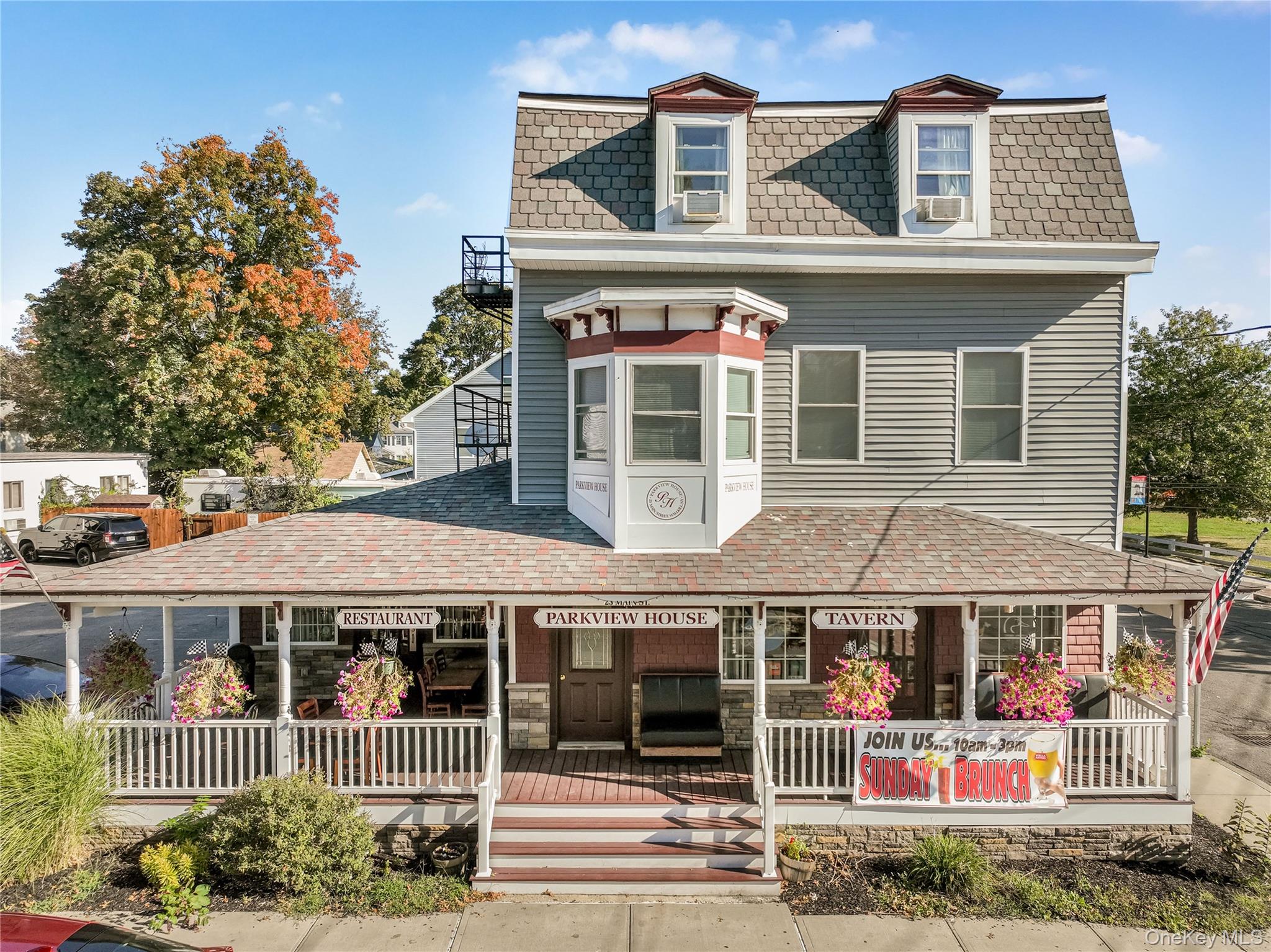 This exceptional mixed-use commercial property in the Hamlet of Wallkill offers a rare investment opportunity combining a fully operational restaurant and bar on the first floor with four fully leased residential apartments above, all situated on a prominent 9, 000 square foot corner lot. The building totals approximately 5, 210 square feet and was completely renovated in 2016, ensuring modern systems, updated interiors, and a turnkey condition for both business and residential use.The ground floor restaurant features a 20-seat bar and a spacious dining room, complemented by additional bar-top seating that creates a vibrant and inviting atmosphere. The commercial kitchen is fully equipped with an extensive array of professional-grade appliances, including a large walk-in cooler, designed to support efficient, high-volume food preparation. Ample basement storage provides valuable space for inventory and supplies, making operations smooth and well-organized. The restaurant also boasts a large covered front porch and a generous rear deck, both ideal for outdoor seating and seasonal gatherings, enhancing customer capacity and experience.This establishment benefits from a loyal and well-established customer base, supported by an experienced and dedicated team of employees. As one of the few full-service restaurants in the town, it enjoys steady foot traffic, repeat business, and a strong presence in the community, contributing to consistent revenue and operational stability.Above the restaurant, the second and third floors contain four residential apartments, all currently rented to reliable tenants. These units provide stable monthly rental income, complementing the commercial revenue from the restaurant. Each apartment was fully renovated alongside the rest of the building in 2016, featuring updated kitchens, bathrooms, and modern finishes. Separate utilities for each unit allow for straightforward management and billing, while the diverse tenant base adds to the property&rsquo;s strong income profile.The buildingâ€™s corner lot location offers excellent visibility and accessibility from multiple streets, increasing exposure to both pedestrian and vehicle traffic. With plenty of private parking available on siteâ€”a rare commodity in this areaâ€”customers and tenants alike enjoy added convenience, supporting both business growth and residential satisfaction.The propertyâ€™s comprehensive renovation addressed all major components including roofing, HVAC, plumbing, electrical systems, and interior finishes. These upgrades have resulted in a safe, efficient, and attractive space ready for continued operation without immediate capital expenditures.This versatile property is an ideal investment for owner-operators seeking to manage a successful restaurant with built-in rental income or investors looking for a stable asset with multiple revenue streams. The established business, combined with fully leased apartments and a prime location, offers a unique blend of security and growth potential in a highly desirable Ulster County community.Financial details, lease information, and additional operational data are available upon request to qualified buyers. Showings are by appointment only.