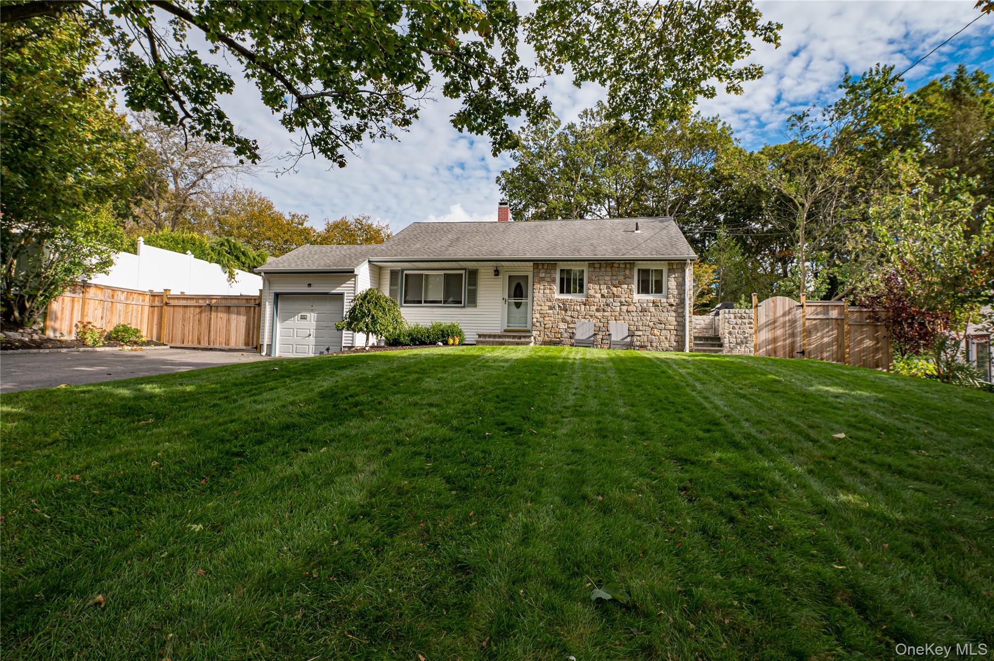 Here is your chance to own a beautiful and maintained home in the highly sought out area of North Smithtown. This 4 bedroom, 2 bathroom home is a must see! The main level features a spacious living room leading to a eat in kitchen with tons of natural light flooding through at all times of the day. The 2nd level features 3 bedrooms with a full family bathroom. Lower level features a large family room/den with a full brand new bathroom laundry & tons of storage. Den leads to large rear extension featuring a bedroom with A walk in closet, and spacious eat in kitchen with sliding glass doors leading to a stunning outdoor oasis featuring a wood burning fire place, retaining wall with natural rock faced wall, landscape lighting, cedar fencing & gates. Irrigation exists in front and back yard. Updates include but not limited to, a new 200 amp electrical service, new heating system, new cesspool, and much more! All set on .25 acre of beautiful manicured property.