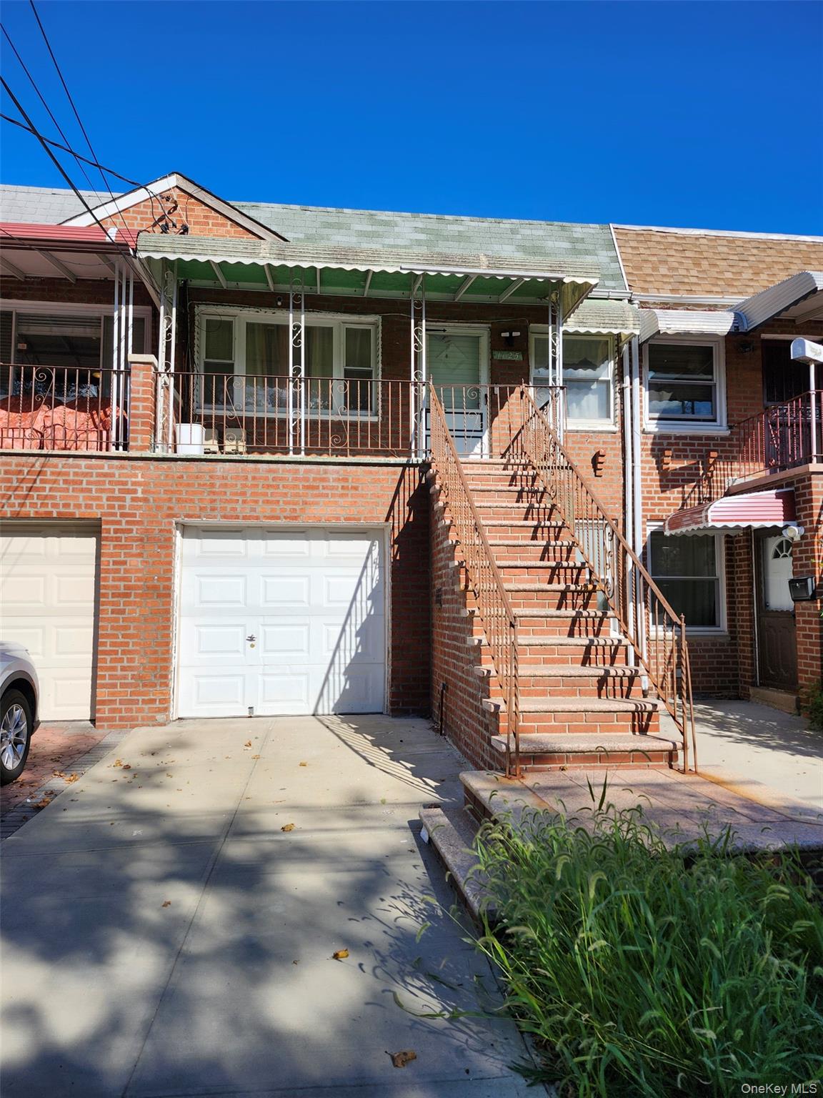 Two Family Brick in the heart of Canarsie, 3 bedrooms, 2 baths with backyard space. Top floor consists of 2 bedrooms, 1 bath and a front patio. First floor has 1 bedroom, 1 bath, and living room . Hardwood floors, and lots of windows giving you that natural sunlight. No Basement.  Parking garage, and nice backyard space for you to entertain.
