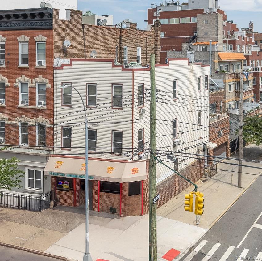Corner Mixed-Use Building with Commercial Storefront, Brick Two-Car Garage & Two Residential Units A fantastic opportunity to own a semidetached mixed-use corner building in the heart of Astoria! Situated on a high-visibility corner , this versatile two-story property features a vacant commercial storefront with basement, two residential units, and a brick two-car garage with soaring 13â€™ ceilings â€” ideal for investors, end-users, or live/work arrangements. Commercial Storefront with Basement The ground floor offers a high-exposure commercial space, ideal for office, retail, or service-based businesses. A full basement adds valuable storage or workspace potential. Also on this level is an extra-large brick two car garage with 13-foot ceilings and a new electric metal garage door, providing rare and secure private parking. Second Floor â€“ Vacant Flex 2- Bedroom Unit This bright and spacious apartment features 9-foot ceilings and oversized windows drawing in natural light from three exposures. Configured as a large one-bedroom with a flexible second bedroom layout, the unit includes an open kitchen with center island, sunlit living room, full bath, and access to a finished private terrace â€” perfect for entertaining. Additional features include in-unit laundry and baseboard heating. Unit may benefit from some minor updates, offering a great opportunity to customize to your taste. Third Floor â€“ Vacant 3-Bedroom Layout (Currently Configured as 4 Bedrooms) Currently used as a 4-bedroom, this unit can easily be reimagined as a spacious 3-bedroom apartment. It features high ceilings, a full bathroom, a large landing area, and excellent natural light throughout. With a bit of TLC, this unit holds great potential for transformation into a beautiful upper-level residence or rental. Additional Highlights: â€¢ Gas boiler heating system â€¢ 9 ft ceilings in both residential units â€¢ Corner lot with excellent visibility and natural light â€¢ Flexible layout and usage options â€¢ Located near publictransit, highways, shopping, and more Whether youâ€™re looking to invest, occupy, or redevelop, 23-39 Astoria Blvd presents an exceptional value and opportunity in one of Queensâ€™ most vibrant neighborhoods.