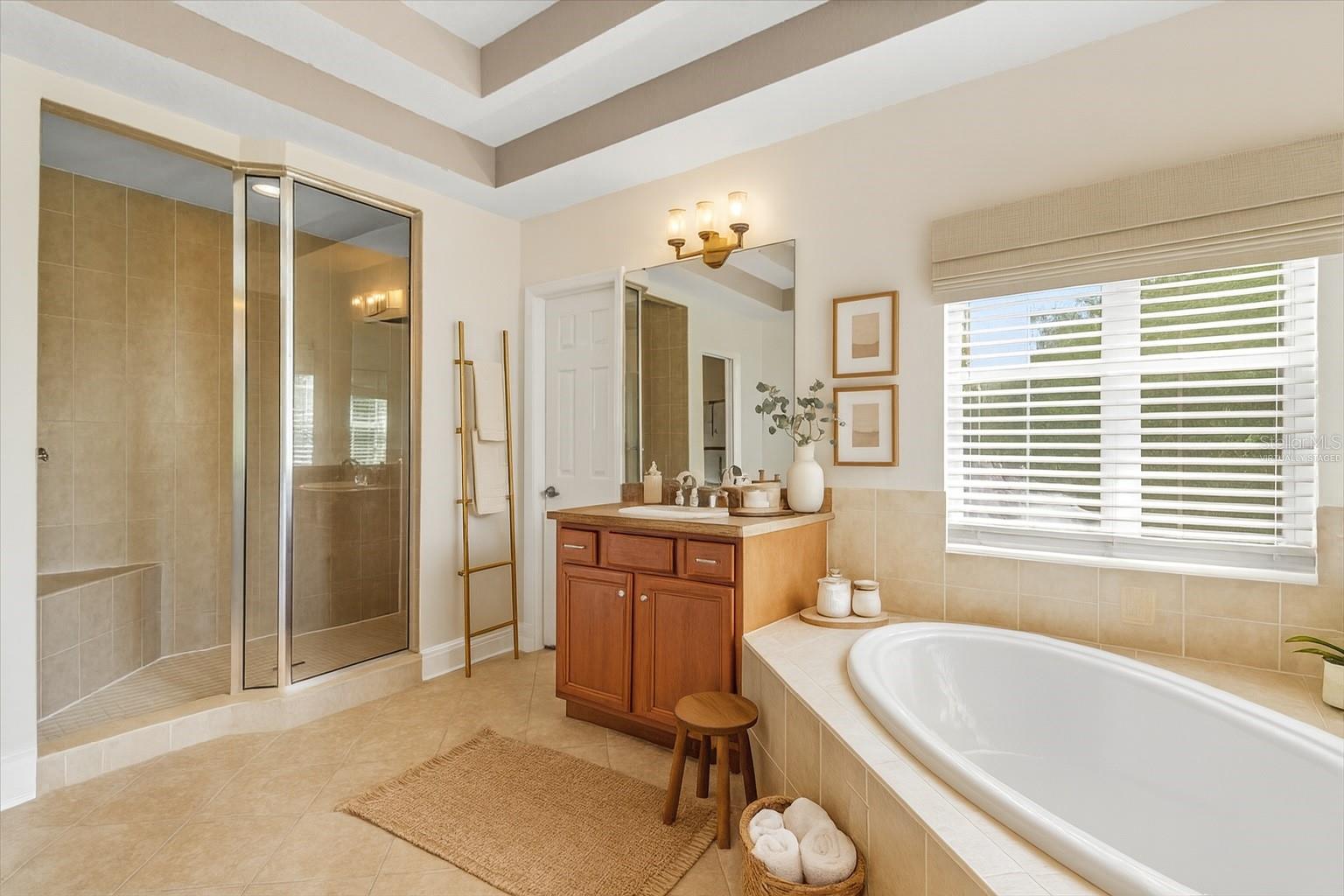 Other view of master bath with walk in shower and additional vanity virtually staged
