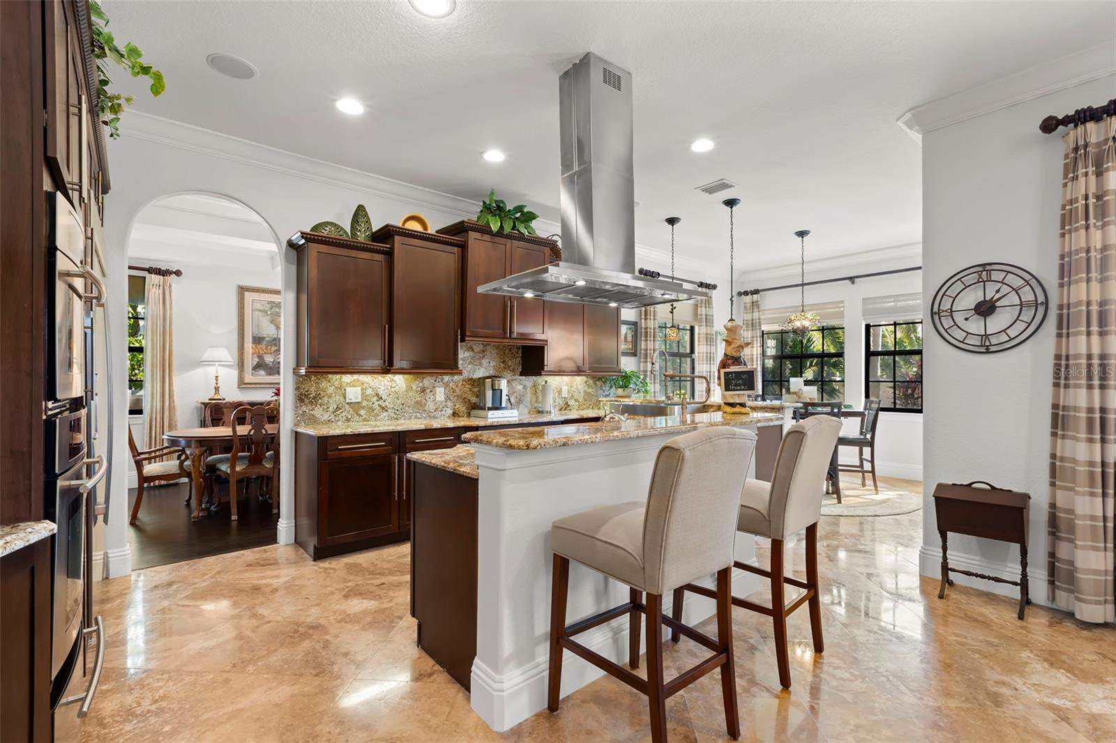 Gourmet kitchen with gas cooking and wine bar.