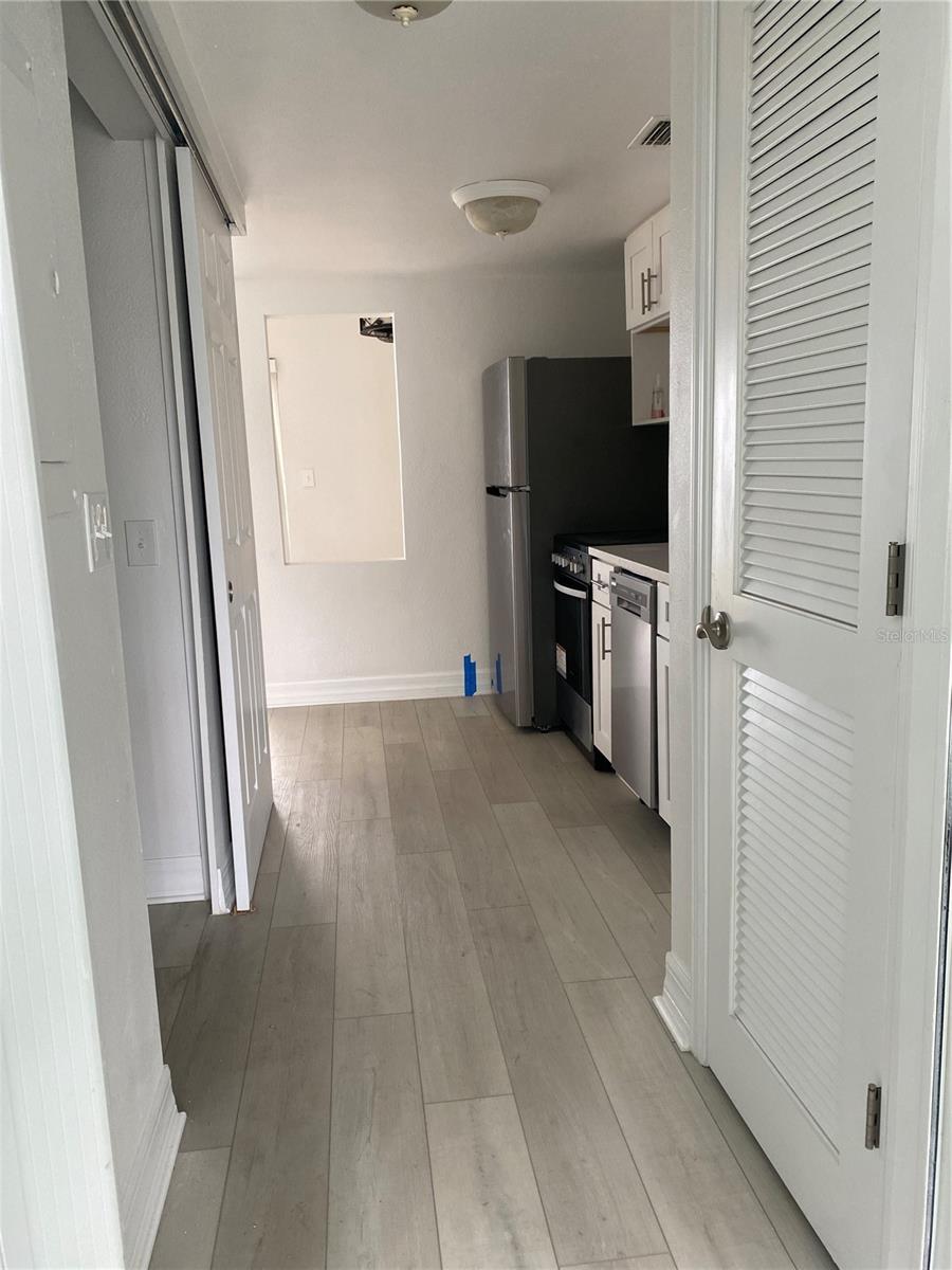 View from front door after remediation - to the right is the HVAC closet, then the kitchen. To the left is the lavatory.