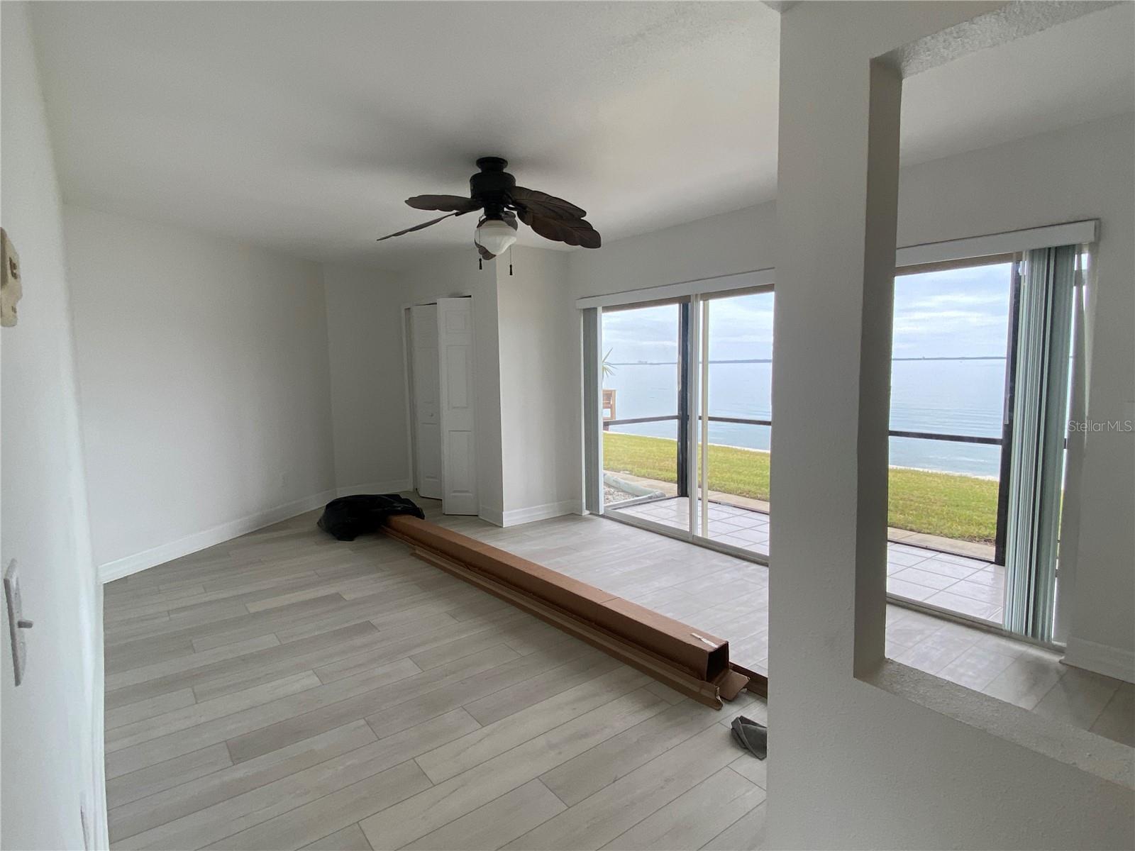 Your back is to the kitchenette, view into the great room. Check out the water view!!!Straight ahead is a closet (which can actually be removed if you wanted different space) (box is for the new blinds)