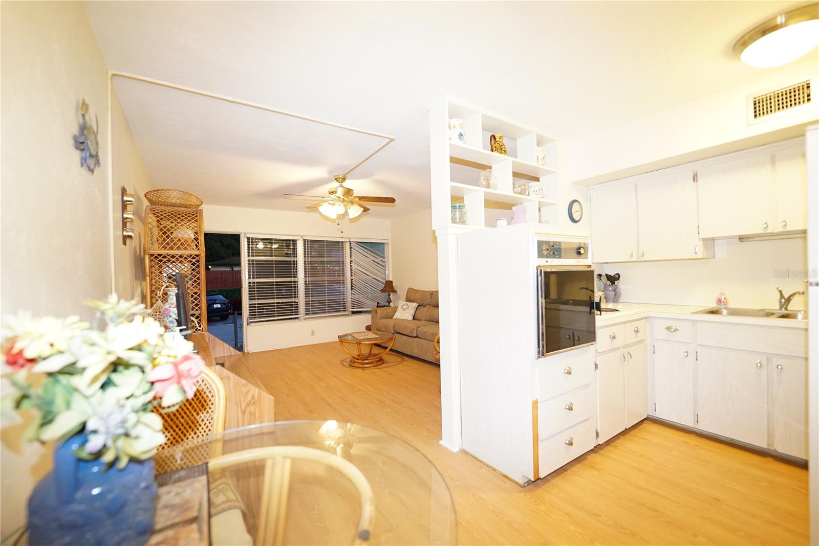 One side of kitchen visible with built in oven and cook-top