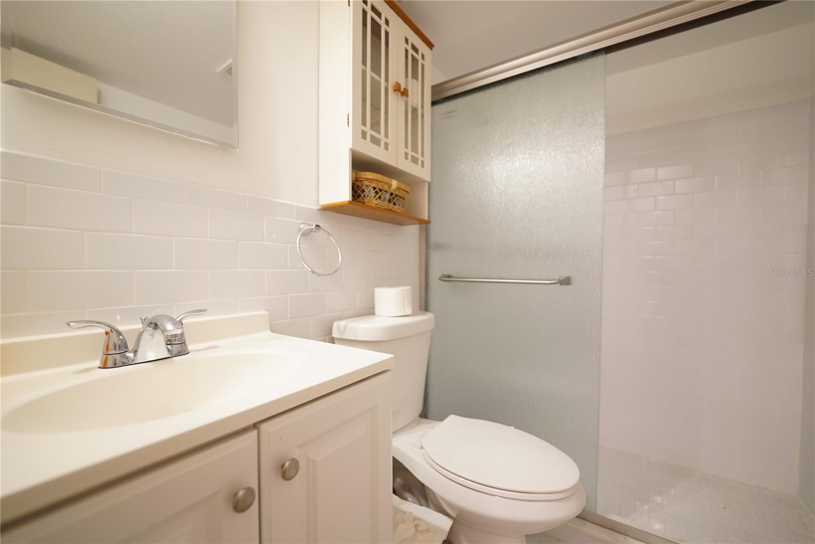 Bathroom with remodeled walk-in shower, newer toilet, newer vanity...